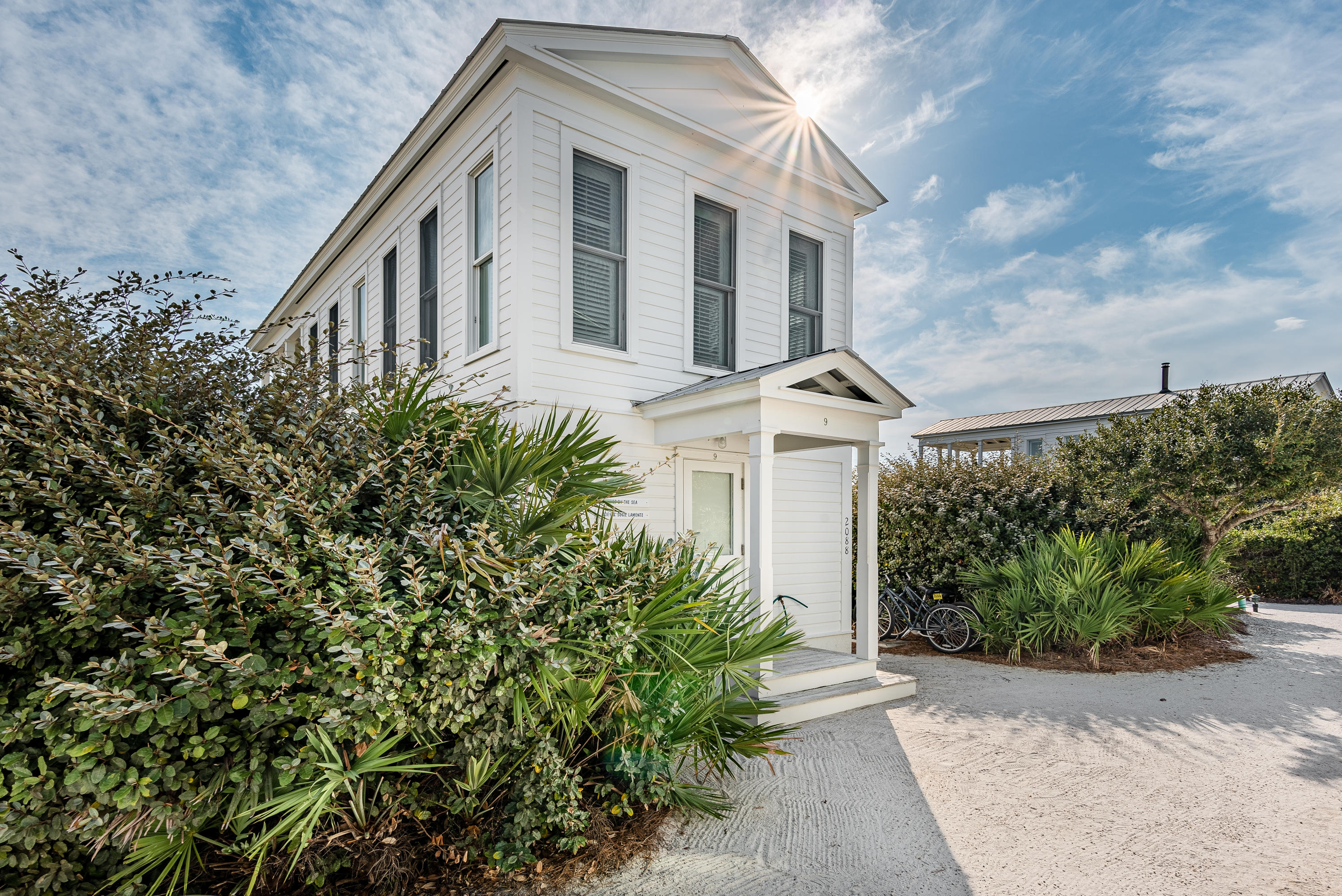 Here is an opportunity to own one of Seaside's original ''Honeymoon Cottages''. This hidden gem is tucked away amongst a thick grove of dune oaks exhibiting the world renowned charm of Seaside. As you enter this beachfront cottage, the all white wood painted interior welcomes you with its simplistic warmth. The first floor master bedroom opens to a private screened-in porch with an outdoor whirlpool tub and peaks of the Gulf through the dune oaks. The master bathroom boasts a huge steam shower and beautiful tile floors. Upstairs you will find an open concept floorplan with kitchen, living and dining space that opens to a covered porch with gorgeous gulf views. Enjoy the gulf breezes and dine under the stars from the upstairs porch or admire the exquisite architecture of the Pensacola Beach Pavilion from both levels.  This pavilion provides convenient access to the sugar white beaches of South Walton.  Take yourself back in time when walking, biking and spending time together was the way of life.