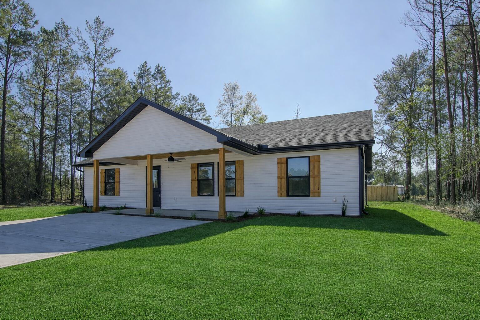 This stunning 3-bedroom, 2-bath home by Darby Homes blends modern comfort with timeless Southern charm. Relax on the welcoming front or back porch, highlighted by cedar-wrapped posts and cedar plank ceilings. Inside, the open-concept design features durable LVP flooring and a spacious kitchen with island, soft-close cabinetry, stainless steel appliances, pantry, and a laundry room with added storage. The primary suite offers a walk-in closet, double vanities, and a custom tiled shower with glass enclosure. Quartz countertops throughout and energy-efficient spray foam insulation add style and savings. Fully sodded yard plus up to $9,000 in seller credits with an acceptable offer.