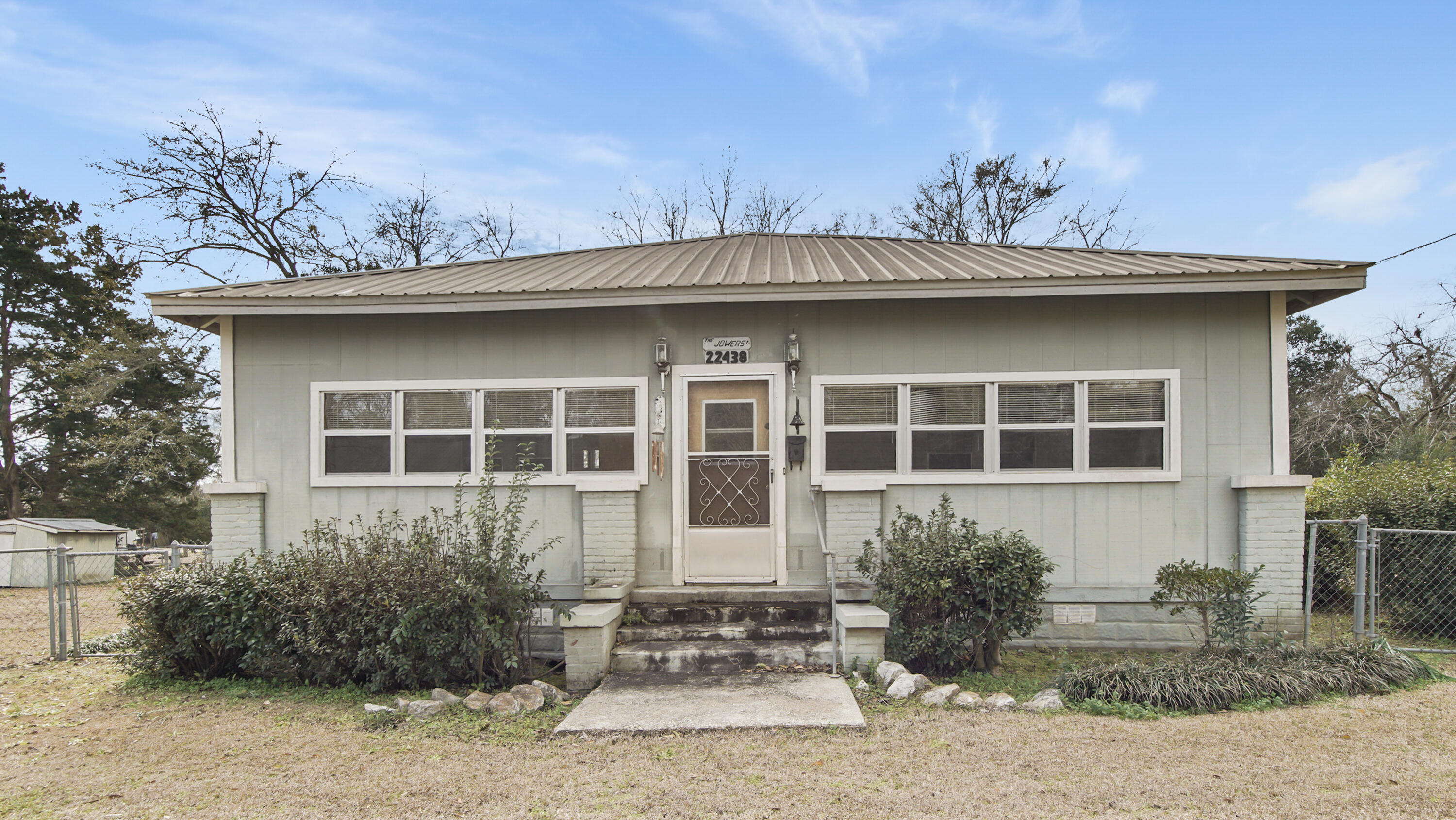 Located in Florala, this home at this price gives you the opportunity to make it into your own. Offering 2 BR, 1 BA, living room, kitchen and an enclosed porch area for more room for your family. Home sits on a large lot that includes an additional parcel with power and water already on it that could give you room for and additional home as well. The chain-link fenced yard gives comfort of safety for outdoor play for both your animals and children. Property has numerous outdoor storage buildings to include a 24X24 workshop/carport as well as additional out building spaces.  Located within minutes to the school, football fields, and parks the location is an easy commute to all the things in Florala to include Beautiful Lake Jackson. Call today to see this become your dream restored.