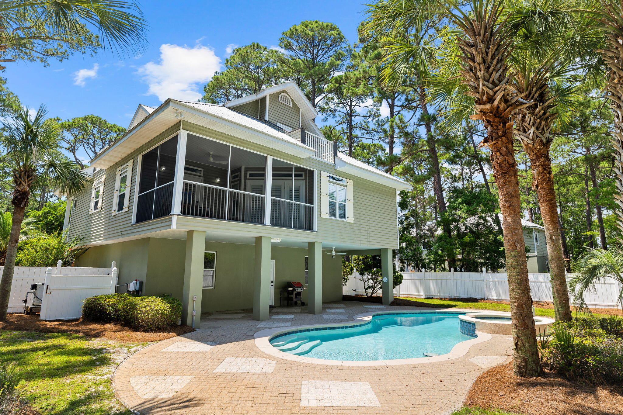 Location, location, location! This Dune Allen home is a serene coastal retreat nestled near the glistening waters of the Gulf and the tranquil beauty of Oyster Lake. The exterior of the home boasts a charming seaside aesthetic, with large porches providing sweeping views of the surrounding natural landscape. A spacious screened deck extends from the rear of the home, offering a perfect spot for relaxing and enjoying the salty breeze. The large private pool, with submerged seating plus a hot tub and waterfall feature, invites you to outdoor relaxation. The home's features, such as vaulted ceilings and open floor plan, create a welcoming and spacious atmosphere. The kitchen boasts custom cabinets, a new oven and cooktop, stainless appliances, including a Bosch dishwasher & a breakfast bar. The natural light in the dining area creates a lovely ambiance for meals. French doors open to an inviting screened in porch overlooking the pool and back yard. The primary bedroom has a nicely wood trimmed walk in closet and a large bath with double vanities, an updated shower, and a spa tub. There are two bedrooms and two baths on the main level and two bedrooms and a bath on the upper level, plus a nice loft area that would be great for an office, kids play room or bunk area. The laundry room features extra cabinets for storage. The concrete block construction first level features oversized divided garages which offer space for multiple cars, a boat, and/or a golf cart. There is an interior stairway, providing the option to convert one side of the garage into an additional bedroom, game room or mother-in-law suite. The absence of an HOA allows for flexibility in keeping a boat or RV on site. The RV parking pad is complete with a 50 amp power source. Two new AC units were installed in 2023. The proximity to popular spots on 30A's west end and easy access to the beach via bike or golf cart make this location ideal for a peaceful primary home or investment property. This seaside paradise with salty smells and the rustling of palm trees create a symphony of relaxation and rejuvenation.