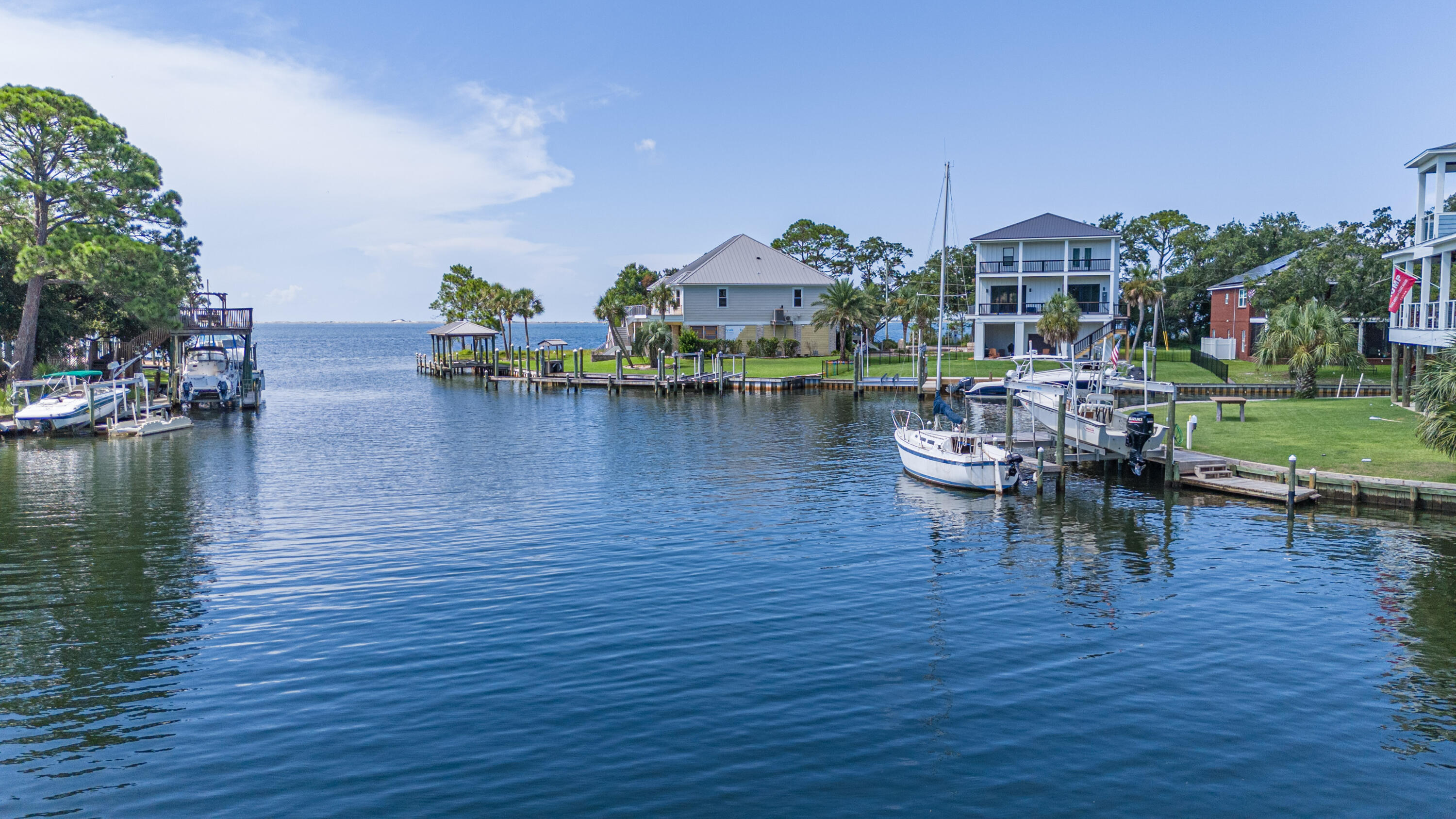 Welcome home to this beautiful and unique property, situated on over 270 feet of canal-frontage, yet still offering ample space for a pool. The home features six large bedrooms, providing ample space for tranquility, three of which have balcony access overlooking the water. Speaking of water, the canal is part of a small inlet that allows for quick and easy access to the Bay. The possibilities are endless, with features like Natural gas in the kitchen and the fireplace, a screened-back porch overlooking the water, an oversized garage with plenty of space for vehicles and a workshop, a climate-controlled space over the garage, an outdoor fire pit, and an outdoor shower. The list goes on and on, as does the potential for this great home. It has seen many stories and shared many memories. 270 feet of canal-front property still has plenty of space for a pool. The home features six large bedrooms that give ample space for tranquility, three of which have balcony access overlooking the water. Speaking of water, the canal is part of a small inlet that allows quick and easy Bay access. The possibilities are endless, with features like Natural gas in the kitchen and a fireplace, a screened-back porch overlooking the water, an oversized garage with ample space for vehicles and a workshop, a climate-controlled space over the garage, an outdoor fire pit, and an outdoor shower. The list goes on and on, as does the potential for this great home. It has seen many stories and shared many memories. Now it's time to make this your own and create your memories.