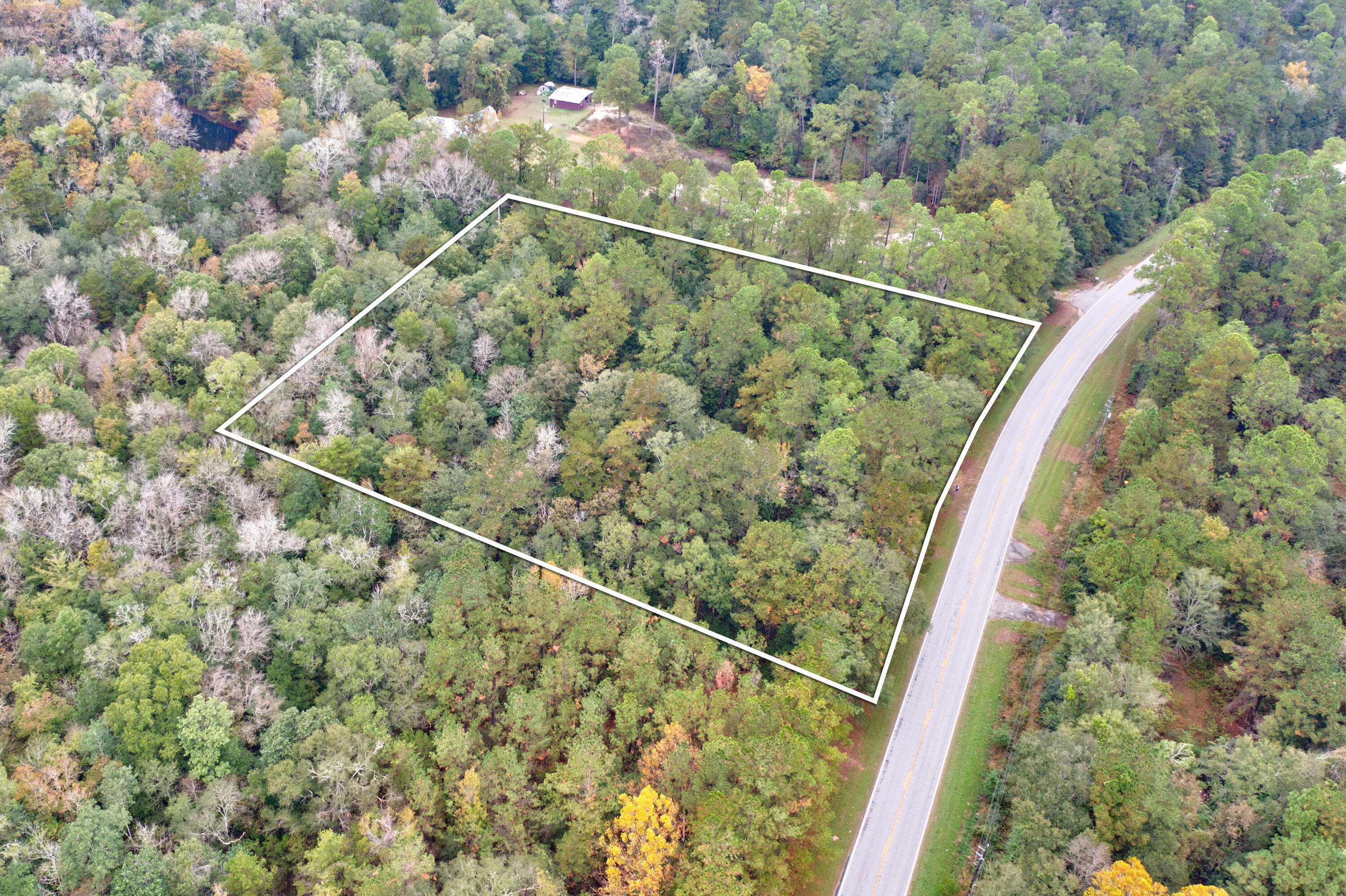A serene 2.43 - acre property tucked away in nature yet close to conveniences, complete with  essential utilities (power, water, and septic) and a small existing structure. This setup could serve as an immediate base for outdoor activities and offers the enticing possibility of developing a cozy ''cabin in the woods''The structure provides a foundation, while the land invites creativity - imagine a warm, rustic cabin surrounded by trees, a garden and space for trails. A tranquil retreat and/or great space for a vacation investment property!! Want to get away amongst the trees, this your place!