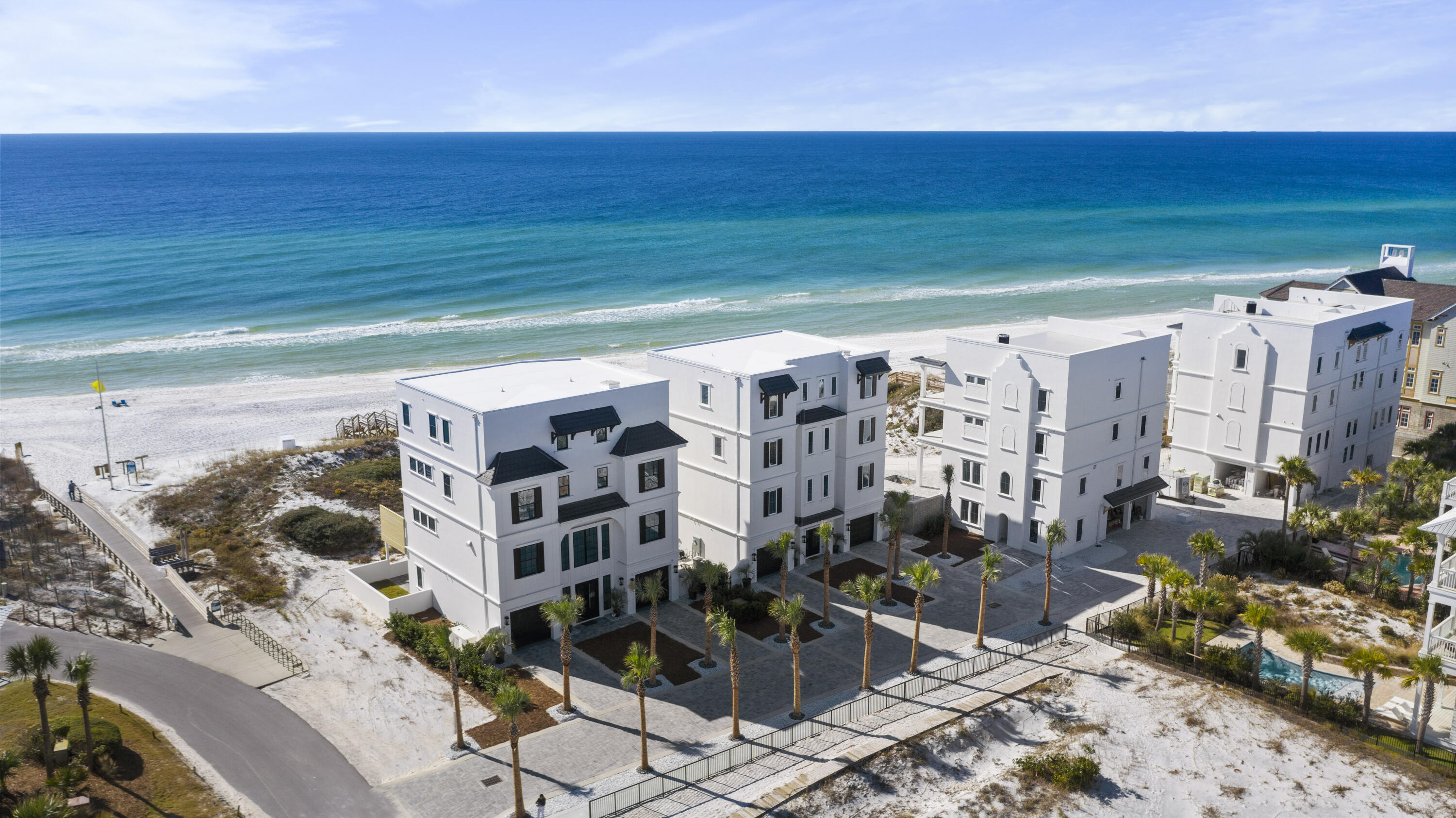 Exceptional new construction Gulf front home that exemplifies true luxury. Even the street name itself ''Azzurro'' means blue in Italian to mirror the crystal clear blue waters of the Gulf of Mexico. This 7-bedroom home boasts 5,218 sq. ft. and is situated on a 1/2 acre lot with a private dune walkover to the beach, 62 feet of Gulf frontage and plentiful outdoor areas including the elevated Gulf front pool on the second level. Superb design and attention to detail is evident by Eric Craig of B. Design's approach. There is a true flow to the home along with beautiful architectural lines, 10-11 ft. ceilings and stunning finishes including Quartz, porcelain tile and custom mosaic work, shiplap, whitewashed spruce ceilings, Kohler fixtures (majority) and unique lighting throughout the home. With ICF construction on the first floor, dune protection, great elevation, superior insulation, 4 AC units seer 18 with built in dehumidifiers, tankless hot water heaters, central vacuum, security system, smart features and 2-car garage with plenty of exterior parking make this home a prime choice. The black shutters, garage doors and trim against the crisp white exterior create a nice contrast and unique look. When you walk into the first floor, there is beautiful decorative tile in the welcoming foyer that flows into a living area with direct access to a fantastic paver deck ideal for a dining or entertainment area or even an outdoor pool table. There is additional storage under the home or to the right for all your beach gear that completes coastal living - kayaks, paddle boards and bikes. Also on the first floor is a custom bunk room with lighting by each, a cage fan and small closet area with built-in shelving. There is an incredible bathroom with decorative tile flooring, Quartz vanity, and walk-in glass shower with magnetic shower head and herringbone tile surround. Laundry is featured on the 1st and 3rd levels and the pool bath and wet bar complete with Sub Zero beverage fridge makes entertaining easy right off the beach. There is an elevator with tile and wood panels or beautiful wooden stairs to the upper levels. The second floor encompasses the great room and stunning dining area facing the Gulf, state-of-the-art kitchen and a bedroom with an en-suite bathroom and additional half bath for convenience. Capture breathtaking Gulf views from the large windows and sliding doors that open up to the covered balcony and elevated heated pool & spa with metallic mosaic detail and beautiful glass surround to maximize the views. There is plenty of room for loungers or outdoor dining area and wooden privacy walls on each end along with a summer kitchen complete with gas grill. Access the dune walkover directly from the pool deck. The interior kitchen offers top of the line appliances like the stainless steel Sub Zero fridge, additional ice maker and beverage fridge and Wolf dual fuel stove with 8 burner gas cooktop with griddle and electric oven with conventional and convection capabilities. There is beautiful cabinetry - soft close, of course, under mount lighting, granite breakfast bar and countertops and glass subway tile backsplash. Beautiful architectural details are noticed like the whitewashed spruce tongue & groove ceiling over the dining area and coffered ceiling in the living area. The living area is generously sized and has a fantastic LED fireplace, contemporary in styling with glass rocks and colored lighting. The living area is staged with upscale furniture for a warm setting. Wood-like tile is great for easy maintenance by the beach and extends throughout the majority of the home along with clean 8" baseboards and crown molding and plantation shutters on the back and sides of the home. The bedroom on this floor is a good size and a stylish barn door opens up to the en suite bathroom with Quartz vanity and walk-in shower with herringbone subway tile.

Upon the third floor, you extraordinarily have not one but three Gulf front rooms, all with access to the covered balcony! The east room is generously sized with a trayed ceiling and an incredible en suite bathroom with barn door, unique light fixtures, a stunning walk-in shower with custom mosaic tile detail, freestanding tub, double Quartz vanity and large walk-in closet with built-ins. There is a niche off the bedroom which could be a great office or workout room with a door to the balcony. The middle room is being used as a deluxe bunk room with sliders out to the balcony and also has access to a separate bathroom with double vanity and walk-in shower. There is a fantastic laundry room off of this as well with a stackable washer & dryer, beverage center and Quartz counter with cabinetry. Perfect for a coffee and snack station. The west bedroom has sliders out to the balcony, beautiful en suite bathroom with vanity on each side, walk-in shower and large walk-in closet with built-ins. The tile selections in all the bathrooms are truly superb and stand out. Great natural light on this floor and breathtaking views to enjoy.

The top floor exudes relaxation with two master suites and an additional living area overlooking the Gulf with direct access to the balcony. The east master suite is epitome of opulence with an expansive en suite master bathroom with double vanity, freestanding tub and walk-in shower then an immense walk-in closet with tons of storage and even a center island with shelving and Quartz top. Just past the closet is a second master bathroom with a beautiful walk-in shower and additional vanity. The room offers large windows with amazing views, trayed ceiling, and another walk-in closet with windows to the Gulf. The master suite to the west has direct balcony access, a beautiful en suite bath and a walk-in closet. This home has top functionality and storage for full time living but can make the perfect vacation home or rental. It is projected to pull in up to $595,000 annually! Smart features make long distance easy as you can control the temperature, security, pool and garage opener all from your phone. The location is special with a private paver stone street for three Gulf front homes and a Gulf front duplex, three boardwalks and will have large palms for a tropical feel. Seagrove offers many dining and entertainment options and is in close vicinity to Seaside, Alys & Rosemary Beach. Local's favorites like Old Florida Fish House, Buddy's Seafood Market, Beachy Bean Coffee & Coastside 30A are all just a quick bike ride away. Be sure to enjoy Eastern Lake, one of the rare coastal dune lakes just west of the home for fishing, kayaking or paddle boarding in a serene environment. The state park nature trails and paved bike trail are close by too, Deer Lake State Park, and The Hub. Do not miss out on this incredible Gulf front estate and prime investment on 30A.