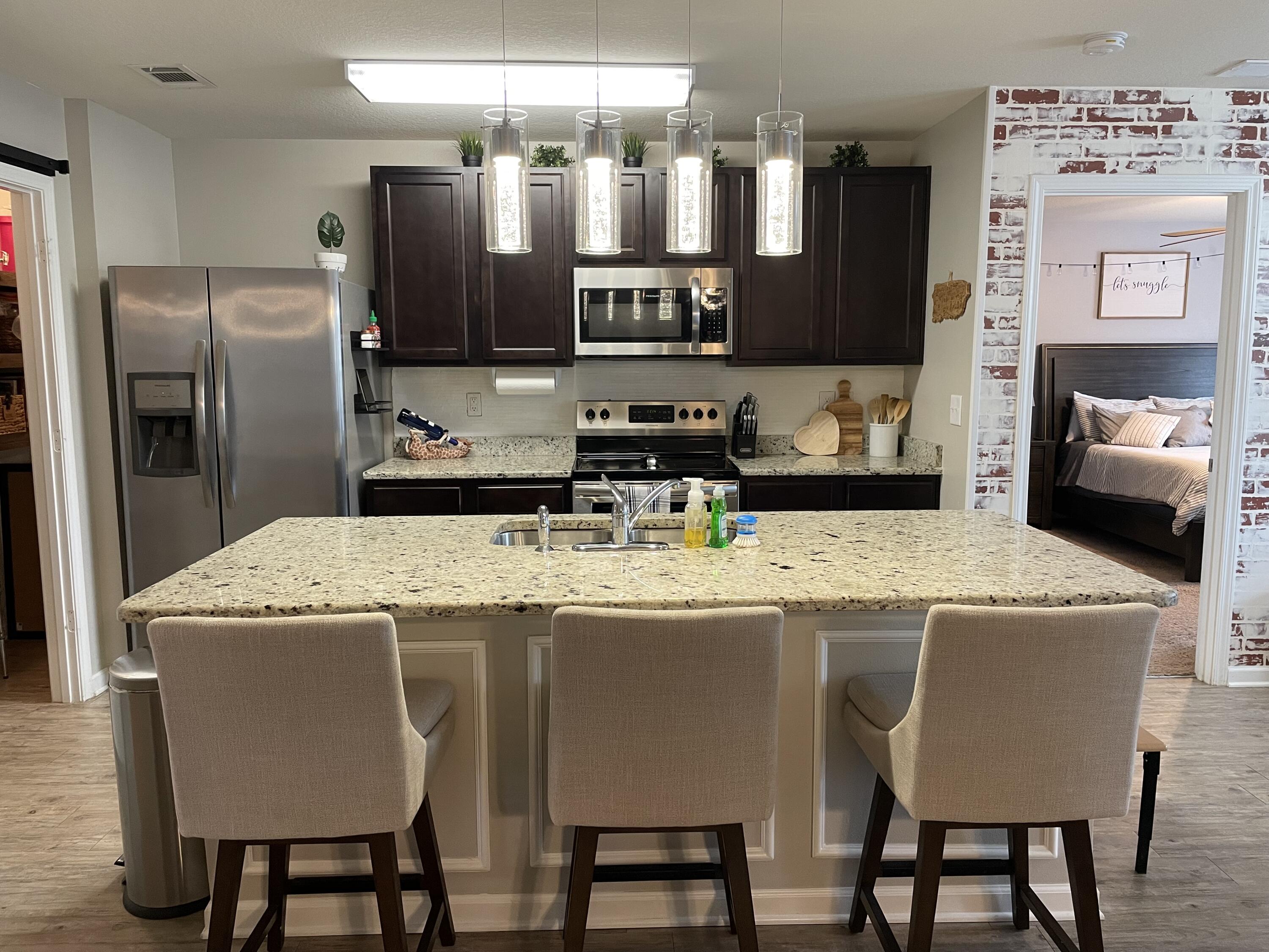Take a look at this HGTV worthy 3 bedroom, 2 bath home with covered back porch, fenced yard & 2 car garage. The open kitchen features an island, stainless appliances and granite countertop. The kitchen opens to the great room w/fireplace & access to the covered porch. The primary suite is just off the back side of the house & primary bath features a separate shower, walk in closet, dual sinks & large soaking tub. Community pool.