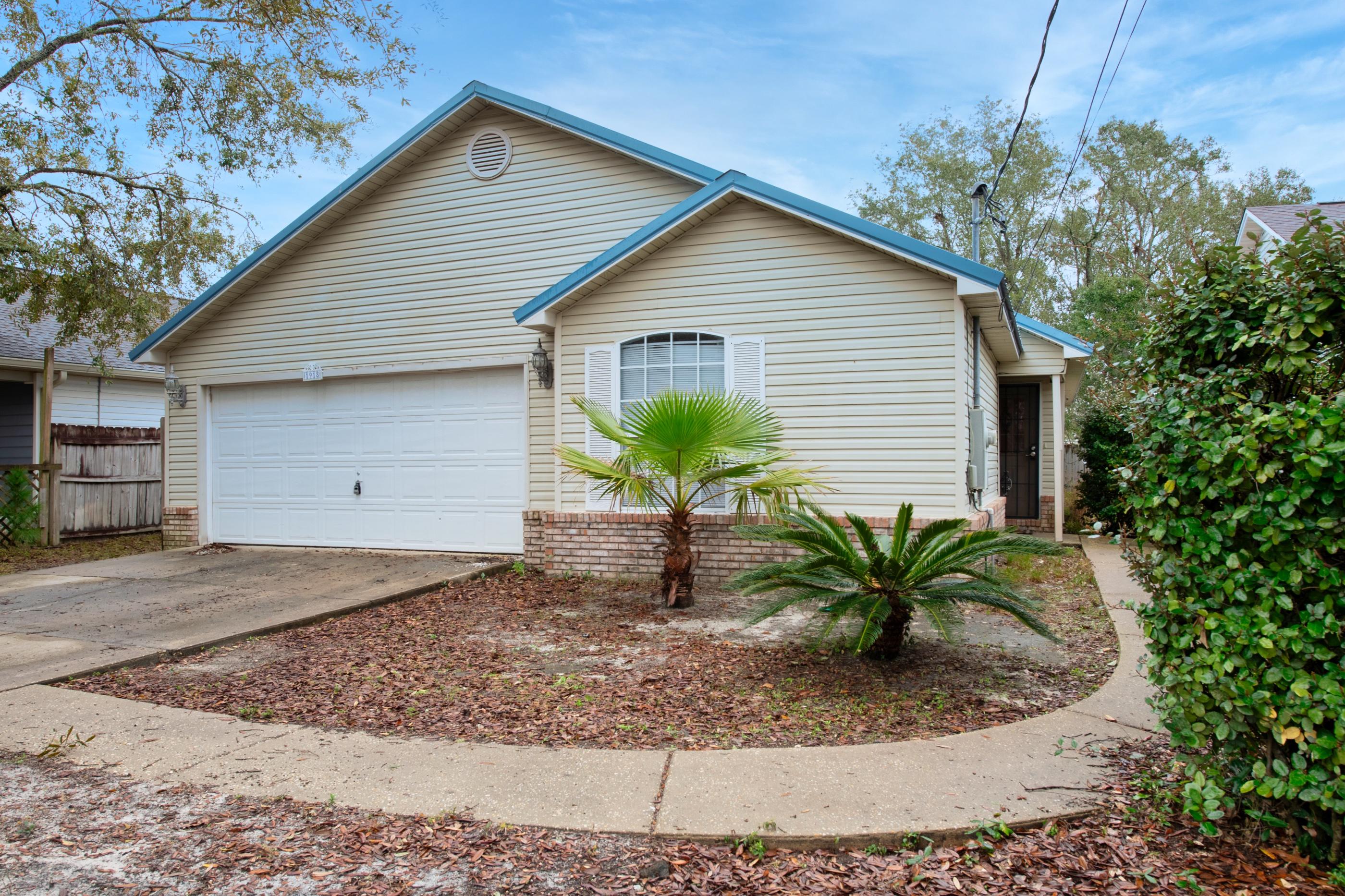 Location, location, location! Wonderful home just a few blocks from Navarre Beach. This fantastic 3 bedroom 2 bath home is great for entertaining with an open floor plan, large kitchen with lots of cabinets and counter space and a breakfast bar that measures almost 9 feet long!! Plus a formal dining area with French doors leading to an open patio. Family room offers a wood burning fireplace and cathedral ceilings. Split floor plan with master bedroom with a walk in closet. The master bath has a sky light and is nice and bright. Home also offers a metal roof, 2-car garage and fenced yard and a large lot that measures approximately 200 feet deep.