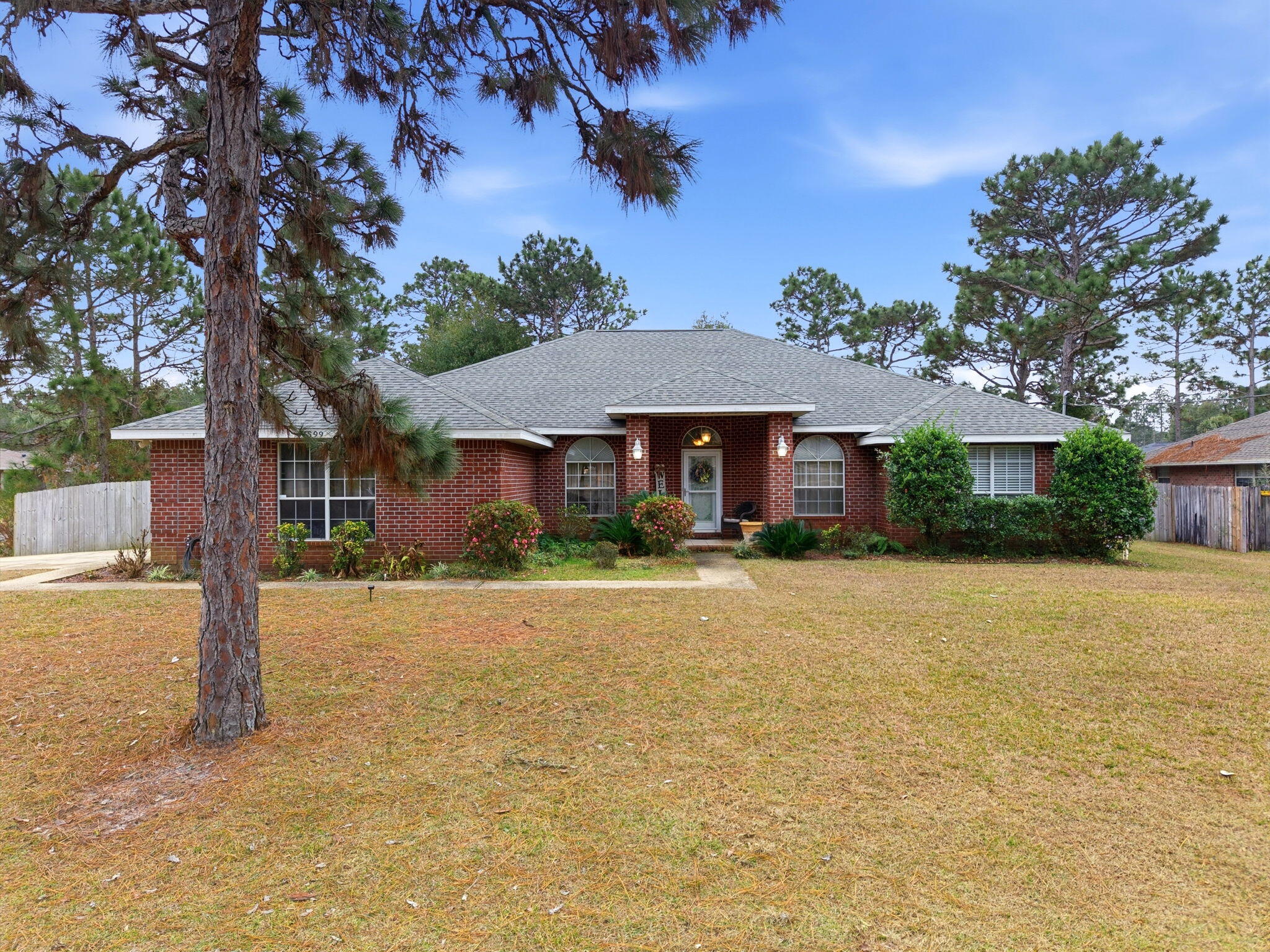 Welcome to one of Holley by the Sea's most desirable floorplans, perfectly positioned on an oversized corner lot with a sparkling inground pool, relaxing hot tub, and expansive outdoor living space ideal for entertaining. This well-built single-level home features a thoughtful split-bedroom layout with a formal dining room, dedicated home office, and spacious living areas centered around a cozy fireplace. The kitchen offers room for an eat-in breakfast area and opens comfortably to the main living space. The generous corner lot still allows space for a pool house, workshop, play area, or boat/RV storage. Light cosmetic updates will allow the next owner to personalize the home, while major systems -- including roof, HVAC, sewer pump, and water heater -- have already been updated.