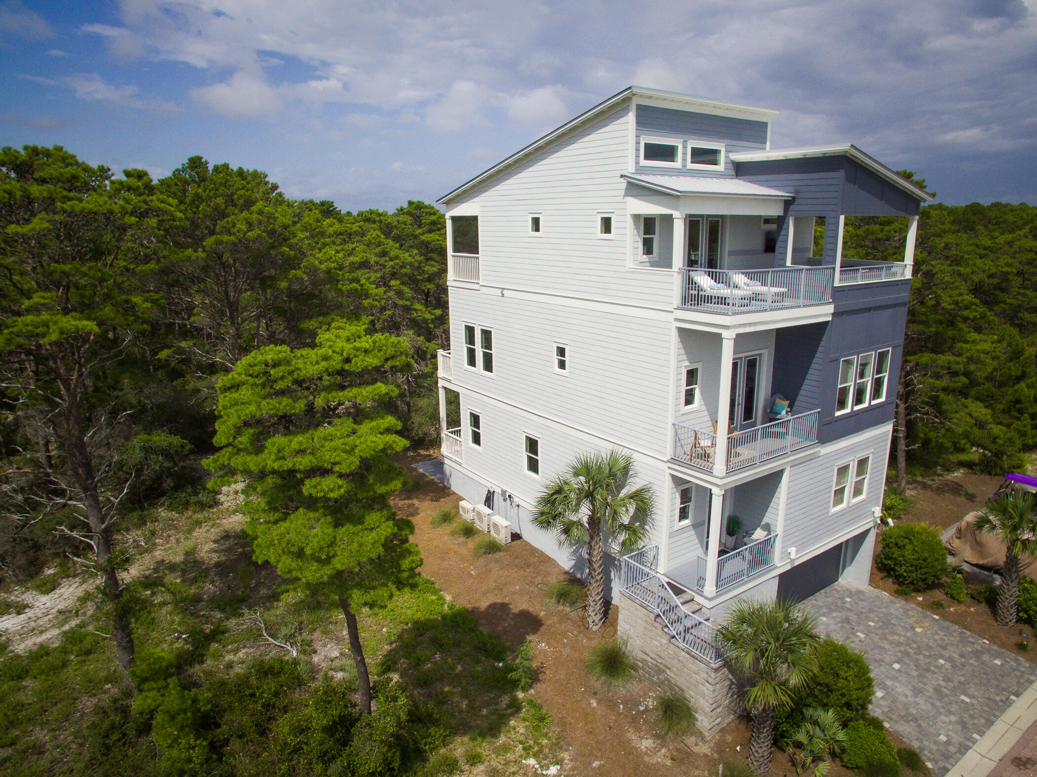 Updated with professional photos.
Majestic contemporary beach home viewing the gulf and a short distance to the beach.  Separate lock out living area on first floor with 2 bedrooms, living, kitchen, and dining. Laundry on first and third floor. Home has a 850 s.f. garage basement for 3 plus cars.  Rear balconies on all 3 levels and a ground entertaining patio.  Front balcony on 2nd level and large master balcony on third level.
  Home is beautifully furnished with all that is needed to move in.