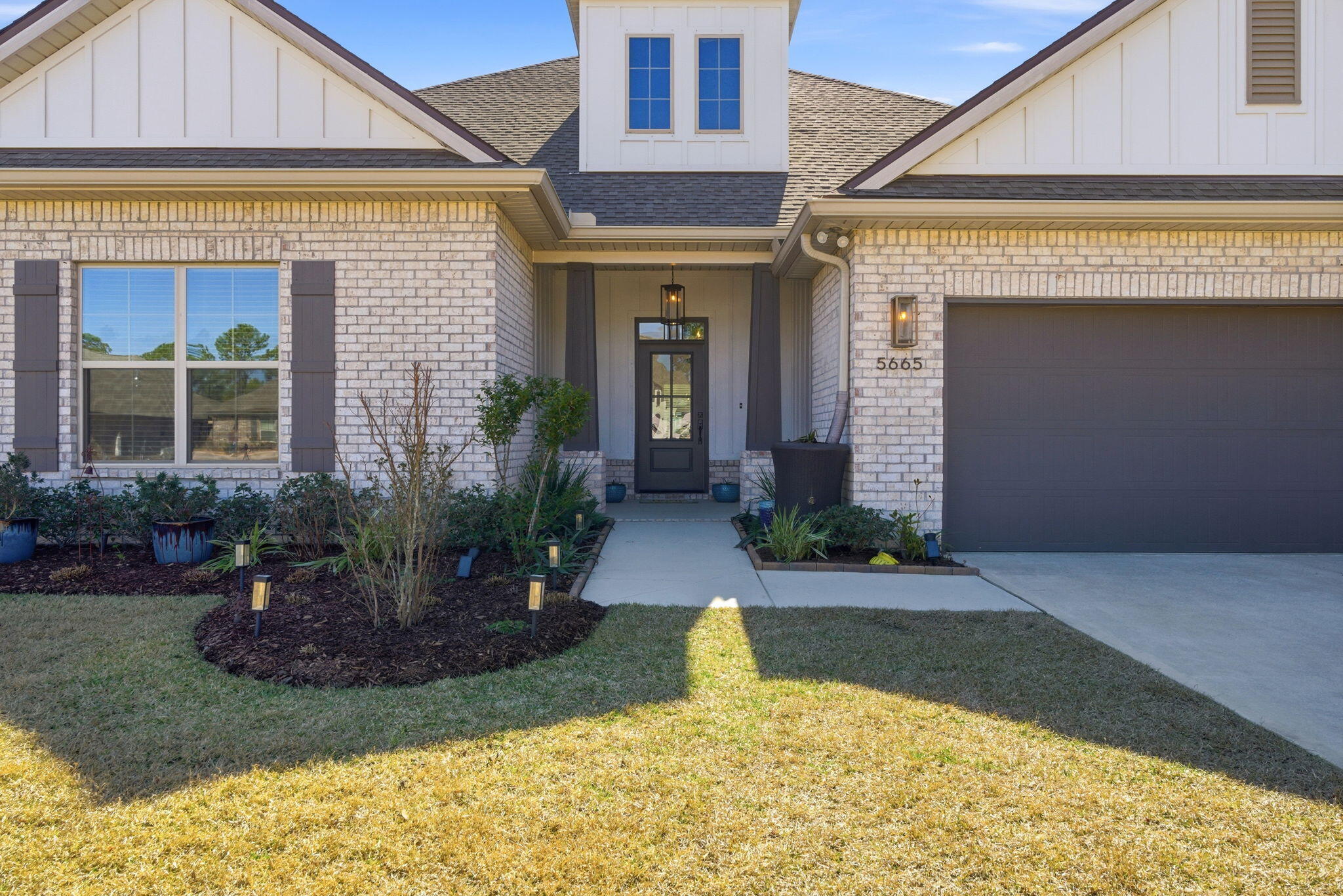 Step into a home that reflects the best of modern coastal style, thoughtful design, & generous living space in one of Gulf Breeze's most sought-after communities, The Sanctuary. This 5-bedroom, 3.5-bath residence, built in 2021 & spanning 3,360 square feet, sits on a large, deep wooded cul-de-sac lot offering privacy, flexibility, & room to enjoy both sophisticated interiors & outdoor living. The main level features four bedrooms, 2.5 baths, & an open living & dining layout anchored by an upgraded kitchen with floor-to-ceiling cabinetry, quartz countertops, premium hardware, a single-bowl farm sink, upgraded stainless steel appliances, a gas 5-burner cooktop, designer backsplash, & under-cabinet lighting. Luxury wood-look tile runs throughout the first floor, complemented by crown molding in the main living areas, entry, kitchen, & primary suite. Additional recessed ceiling lighting installed to enhance the main living spaces, primary bedroom, secondary bedrooms, & upstairs bonus room. The primary suite features a tray ceiling & a well-appointed bath with a custom tiled shower & soaking tub. All closets include wood shelving, & bathrooms feature framed mirrors. Just off the dining area, a spacious office sits behind double 9-foot French doors with two full walls of built-in desks & cabinetry, ideal for work or dedicated creative space. Upstairs offers a large bonus room, fifth bedroom, & full bath, creating an excellent guest retreat or secondary living space. Additional features include Low-E MI windows, high-efficiency Carrier HVAC, central gas heat, a tankless gas water heater, gas fireplace, & a gas line for grilling on the covered back patio. The irrigated backyard offers an oasis & with ample room for a future pool. The Sanctuary sits across from the Intracoastal Waterway with nearby boat ramps & close proximity to beaches, dining, boating, & a scenic waterfront nature preserve park. Schedule your showing & experience this exceptional Gulf Coast lifestyle.