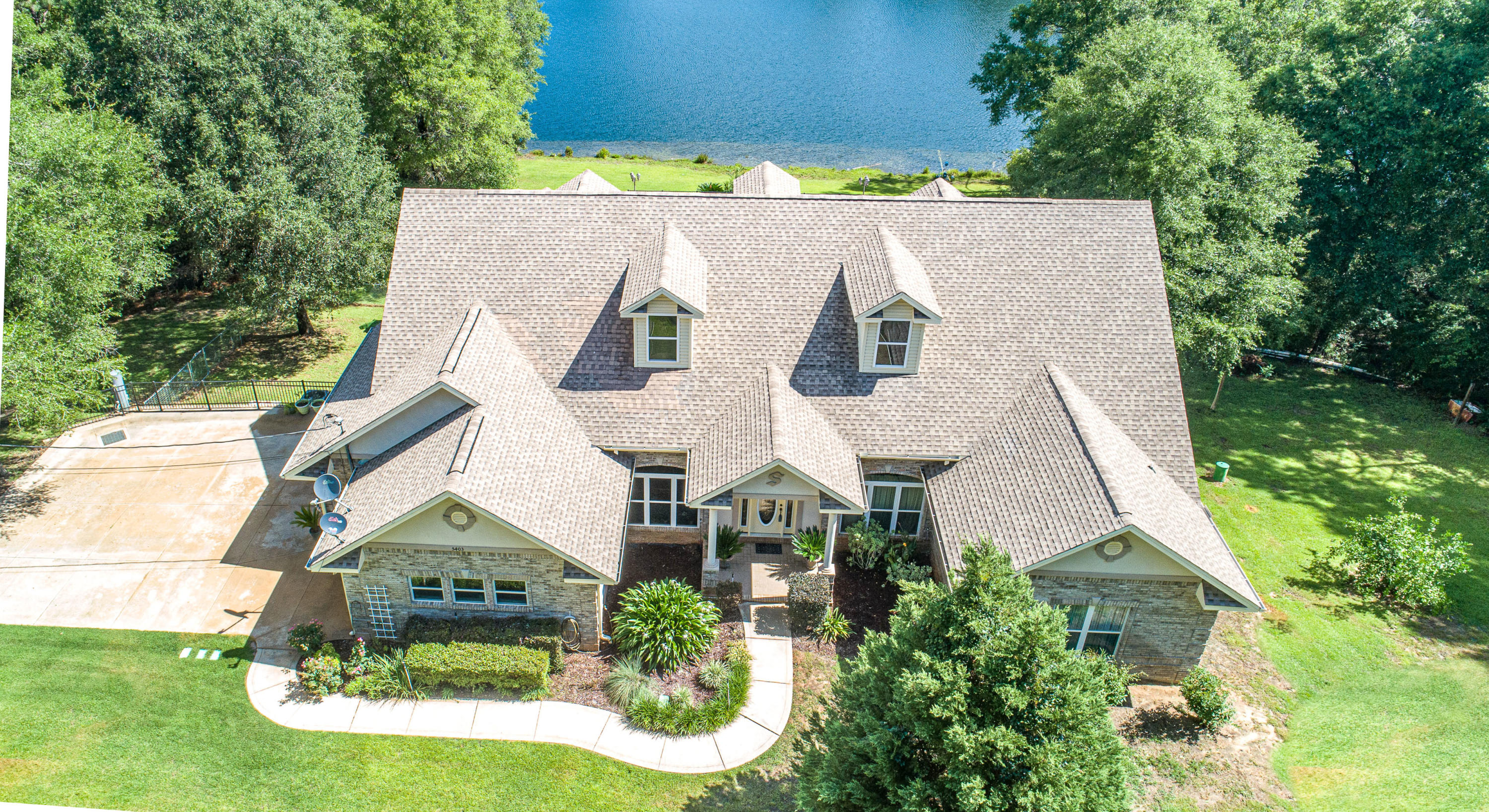 Kick Out Clause in place. CUSTOM Lakefront home on nearly 4 acres! Centrally located, custom brick work, 3 bedroom, 2.5 bathroom, 3 car side entry garage on 1000 feet of lakefront property. This special home features 12'ceilings in the foyer, formal living room, and study. The home offers an open family room has a 12' double tray ceiling with crown molding, gas fireplace, custom cabinets in kitchen, and built in entertainment center, walk-in pantry, surround sound in LR and MB, large closets, crown molding, Granite counter tops, all stainless appliances, travertine tile, whirlpool tub and tile shower in MB, central vac, new carpet, new HVAC, 2x6 exterior walls with R-19, 20 KW generator, Low E windows and doors, irrigation system, security system, 20'x30' gunite pool with 8 person hot tub