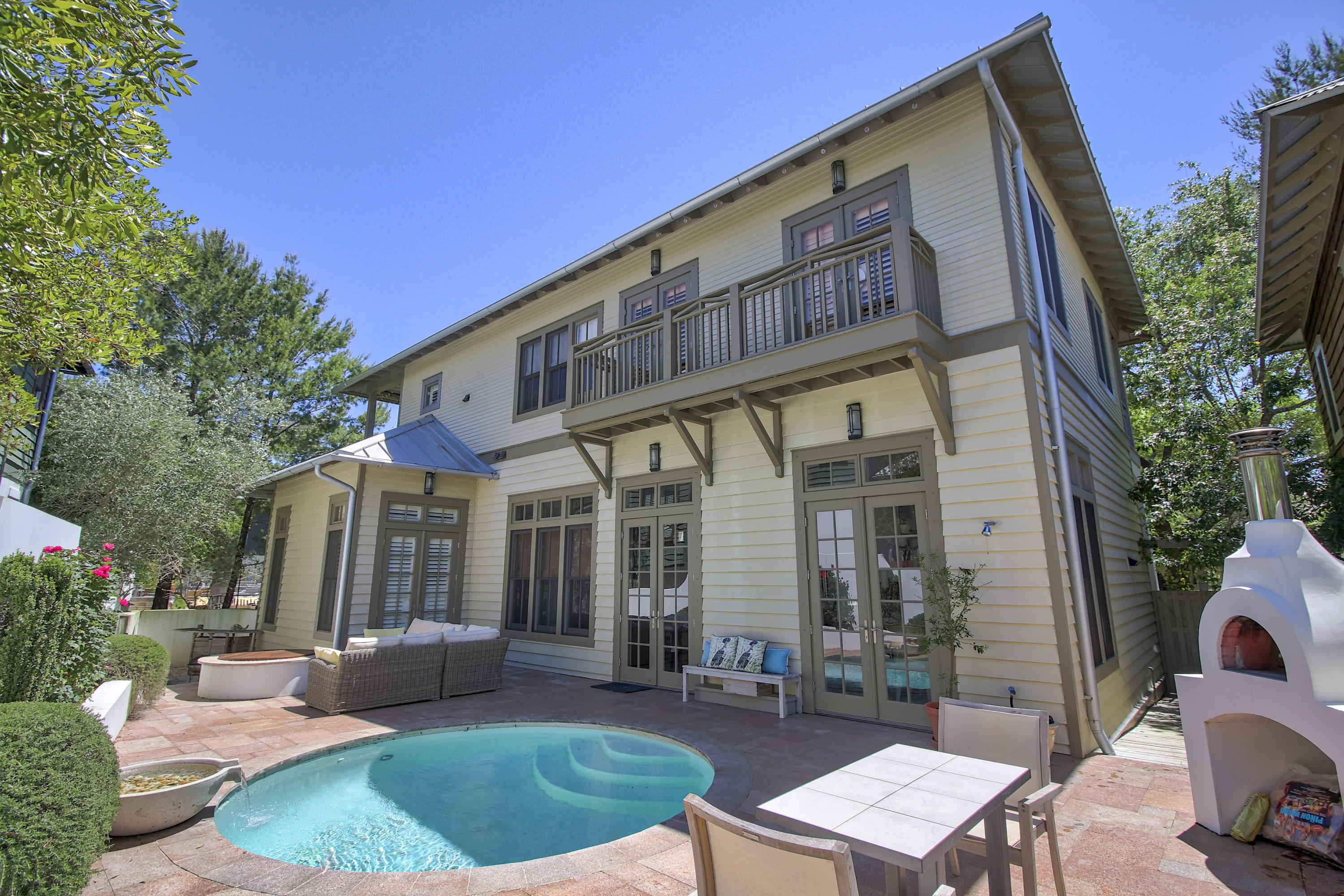 THIS IS THE ULTIMATE BEACH RETREAT! Perfect for entertaining this home was designed with an open floor plan that flows out to the courtyard offering a heated pool, summer kitchen, fire pit, all brick pizza oven and a zen garden. All so you can enjoy outdoor living at it's finest.
The first floor of the home includes the living, dining, kitchen and the master bedroom. The second floor boasts three guest bedrooms each with their own private bath. There is a gathering area and media room for the family to enjoy as well. Wrap around porches on both the first and second floor will invite you to relax and enjoy the tranquility of this wonderful boardwalk location.
The double car garage and carriage house adds even more to this wonderful home. You need to come and see this home for yourself.