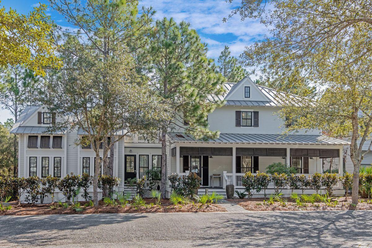 This remarkable custom-built home in WaterColor was designed with family gatherings and happy celebrations in mind. With large picture windows and shady porches, this home epitomizes Southern living at its best. It offers numerous rooms for cozy chats and get-togethers and includes two staircases in the expansive floor plan. Fully furnished, this family-friendly residence is ready to accommodate all your summer guests. The light, bright first floor has low maintenance tile plank flooring and a flow of intimate living spaces including a swoon-worthy kitchen. White drawer-lined cabinets house a plethora of gadgets and appliances. A half-height peninsula and a breakfast bar on either side maintain the open space for conversation in both directions. It creates an orderly food-centric hub for effortlessly serving up snacks, drinks and family meals on the veined marble countertops. There's a separate wet bar with wine cooler to take care of perfectly chilled drinks. More living space includes a formal dining area and TV area along with two guest bedrooms, both ensuites. The second floor accommodates the master suite and an additional guest bedroom and bathroom. The master ensuite has floating cabinets with dual vanities, a contemporary soaking tub and a separate shower. Across the breezeway find a "secret" bunk room/living space that kids will love. Tucked beneath the eaves, it has its own private porch for quiet reading and relaxing. WaterColor amenities are unparalleled and this home is well located to take advantage of them all. It's a short walk to Frog Pool and Camp WaterColor, which has a popular lazy river and poolside cafe. Guests can spend time at multiple pools, head to the exclusive Beach Club or enjoy trying out new watersports at the Marina on Western Lake. Set behind greenery on a quiet cul-de-sac, this beach property has great curb appeal and faces WaterColor Park. Backing onto protected land, the lot boasts natural landscaping and ample parking for three vehicles.