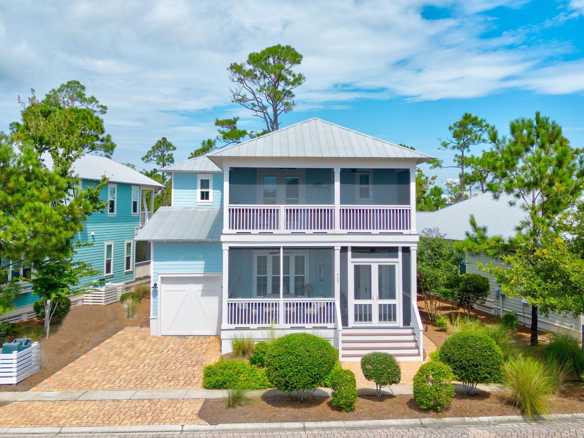 Live the coastal lifestyle you deserve in a prime location just moments from the sugar-white sand beaches of the Emerald Coast in the highly sought-after NatureWalk at Seagrove community. This gorgeous, fully-furnished Sandcastle plan boasts more than 3,000 square feet of thoughtfully designed and professionally decorated living space that brings the Emerald Coast indoors with beach hues and motifs spanning across 4-bedrooms, 5-baths, and an open concept kitchen, dining, and living area that's ideal for entertaining. Plus, there are numerous upgrades that will make any stay one to remember. The expansive chef's kitchen with luxurious natural gas appliances showcases stunning granite countertops, a beautiful white subway tile backsplash, and dark hardwood flooring that compliments the white and blue color scheme that create an aesthetic that's both modern yet cozy. The first floor further flows into an open and airy primary suite that features an oversized closet complete with built-in closet fixtures for organization and ensuite that's the epitome of rejuvenation and relaxation with a large tub and separate walk-in shower. You'll also have your own outdoor oasis whether you prefer afternoons on one of the three covered porches, all of which are screened, that overlook the pond and surrounding preserve, or the full-paver patio surrounded by palm trees and lush landscaping. Additional features of this beautiful home include a natural gas fireplace, with built-in bookshelves, a one-car garage that features an epoxy floor and a climate-controlled storage closet, a two-car brick paver driveway, and a Generac 22kW generator with cellular communication and an automatic transfer switch so that your home can keep running through any storm while two HVAC systems keep the interior at the perfect temperature year-round. The amenity-rich NatureWalk community is situated in a premier location offering accessibility to area restaurants and the Watercolor Publix right next door and amenities such as a trail to the beach that's less than a mile and The Gathering Place that is centrally located and features a playground, heated lap pool, zero entry pool, hot tub, fire pit, grills, TV, bar area for a variety of gatherings and plenty of seating. Other community amenities include fitness stations, multi-purpose courts, pickleball, and a variety of trails throughout. Whether you're searching for an investment property with $110K in projected rental revenue, a second home, or a primary residence, come home to NatureWalk.