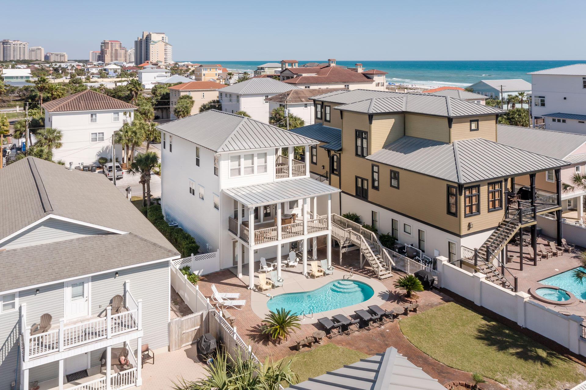 This recently updated home in Miramar Beach features 4 bedrooms and 4 bathrooms. The location is just a short stroll to the white sands and jewel toned waters of the gulf. However you don't have to go beyond the back yard to take a refreshing dip since a lagoon shaped swimming pool awaits you.

The first floor of this three story home has a guest bedroom apartment with a full hall bathroom. This suite has direct access to a covered patio next to the pool. Upstairs is the main living area which is light and bright with honey toned hardwood flooring. A wall of windows with double doors leads out onto the wide covered balcony. The open living area features both living and dining spaces, and the dining area has room for an 8 person dining table. The open kitchen has latte colored cabinetry with mottled granite counter tops and stainless steel appliances. A king bedroom is also on this level with access to a full hall bathroom.

An open rail stairway leads upstairs to the spacious master bedroom suite that has a bathroom that includes a garden tub in a window alcove as well as a separate glassed in shower. Another guest suite is also on this third floor that has its own full private bathroom.