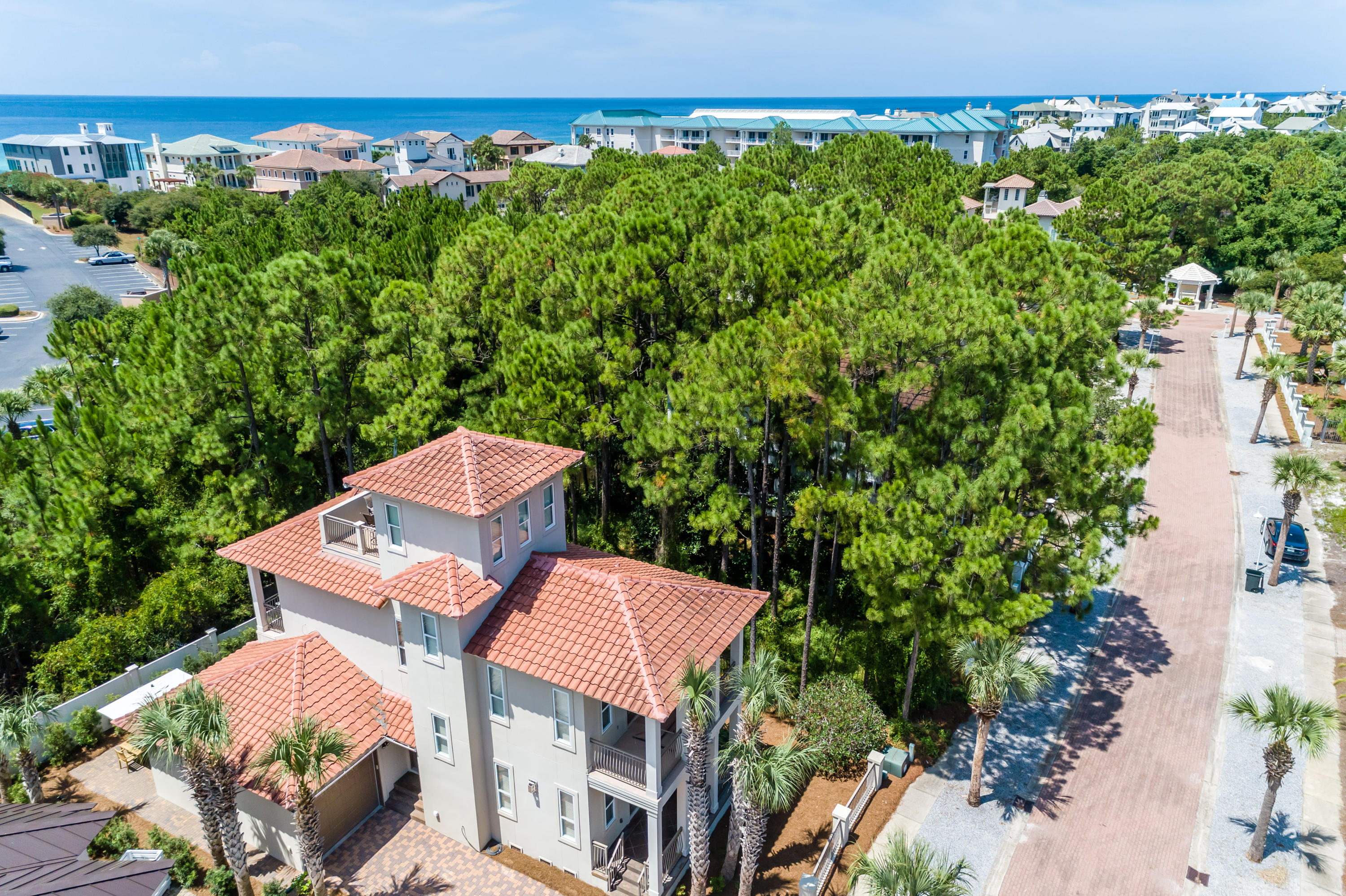 Located just south of popular 30A in quiet Blue Mountain, this meticulously maintained, three-bedroom home boasts oak, hardwood flooring throughout the living areas and gulf views from the 3rd floor balcony. The location of this immaculate home is ideal in the gated, gulf front, rental-restricted community of The Village of White Cliffs and has a PRIVATE DEEDED BEACH ACCESS! The open concept main floor living area provides ample space for entertaining your guests. Natural light flows into the home throughout. The high ceilings and gas fire place create a cozy and instant feeling of home. Flow into the spectacularly remodeled kitchen equipped with stainless steel appliances including a gas cooktop, quartz countertops, pantry and expansive kitchen island with seating for six and even more room for hosting guests. The master bedroom with private balcony and en suite bathroom has a large soaking tub, separate shower and double vanities. Travel to the final and third floor where you can sneak gulf views and enjoy a cocktail from your private rooftop balcony! Or enjoy relaxing on the large, ground floor outdoor entertainment area outfitted with a firepit and plenty of seating. There are four covered porches including one screened-in. The over sized garage is heated and cooled and primed for a carriage house, if desired! 
This quiet, upscale community offers resort-like amenities including a community center, seasonally heated pool, lighted tennis courts and a nature trail. White Cliffs is conveniently located near the bike path and within walking distance to many restaurants and shops. If you are looking for the perfect beach home away from the commotion of tourists this is the neighborhood for you!