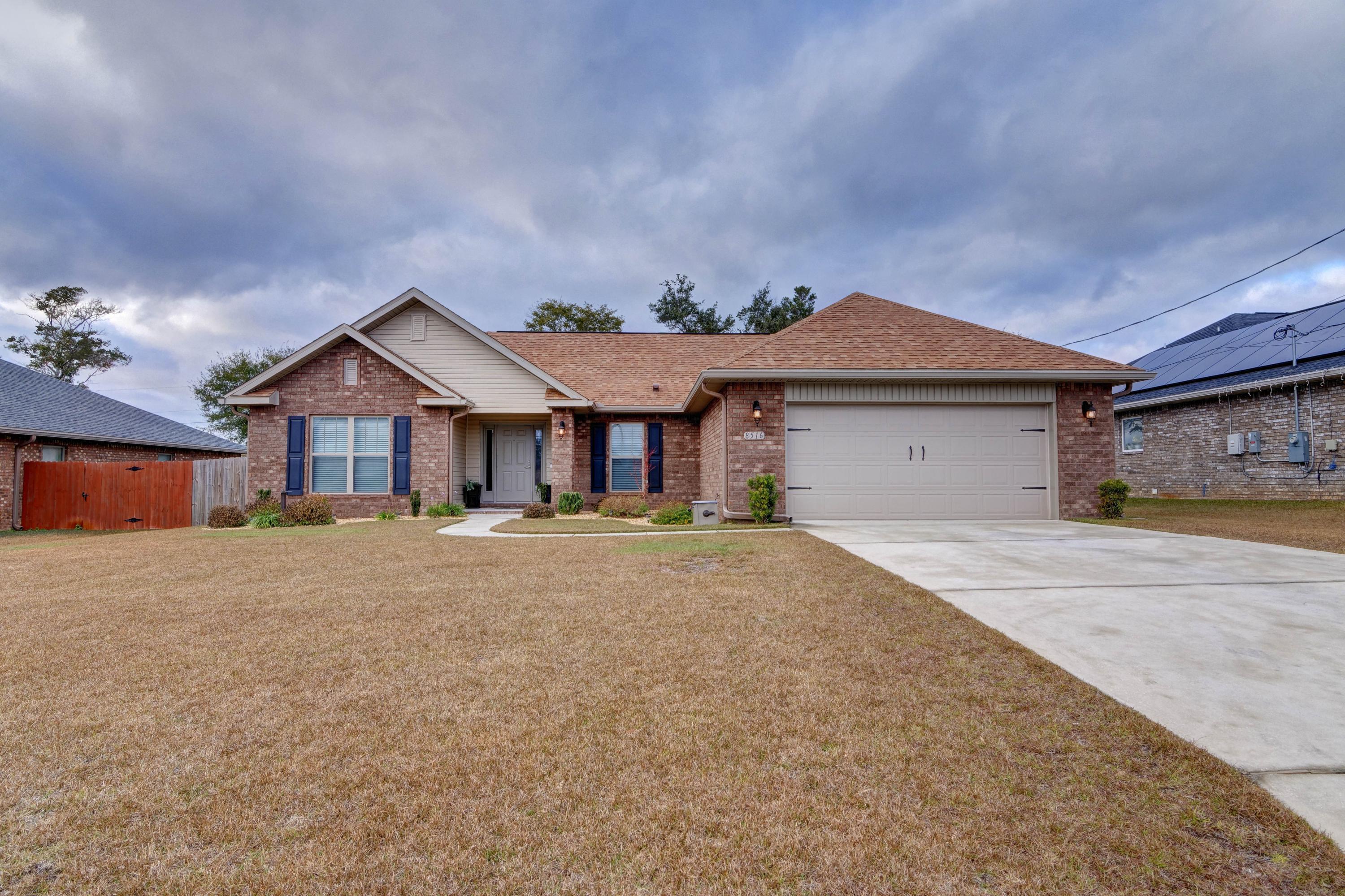 Welcome to this stunning and impeccable open concept all brick Whitworth Builders home that features 3 bedrooms, 2 baths, plus an office space on a quarter acre lot in the extremely desirable neighborhood of Holley Hills! Be sure to check out the provided list of seller updates making this a better than new home! Pull up in the long driveway and appreciate the tasteful landscaping, which will lead you to the covered front porch and inside to enjoy soaring 10ft ceilings. Natural sunlight pours through the multiple windows of the spacious living room, and it's open to the gorgeous and fully updated kitchen. Custom cabinets with granite countertops, over and undermount cabinet lighting, gorgeous glass backsplash, and stainless appliances are showcased in the kitchen, and you'll love the massive kitchen island with tasteful updated pendant lighting. The eat in kitchen leads to the back door where you'll find a covered and screened in back patio. Walk outside and see the beautifully extended patio with pavers and the fantastic fully fenced in backyard complete with a large storage building. The large master bedroom features a trey ceiling and an en suite with double vanity marble countertops, as well as a separate shower, soaking tub, and walk in closet. The split floor plan has two additional bedrooms and a nice sized guest bathroom on the other side of the house, and off the living room you'll find a great office space tucked away. The interior laundry room is located off the two car garage. Don't delay in snagging your spot in this amazing neighborhood with a short commute to Hurlburt Field and close to Navarre's beautiful beaches!