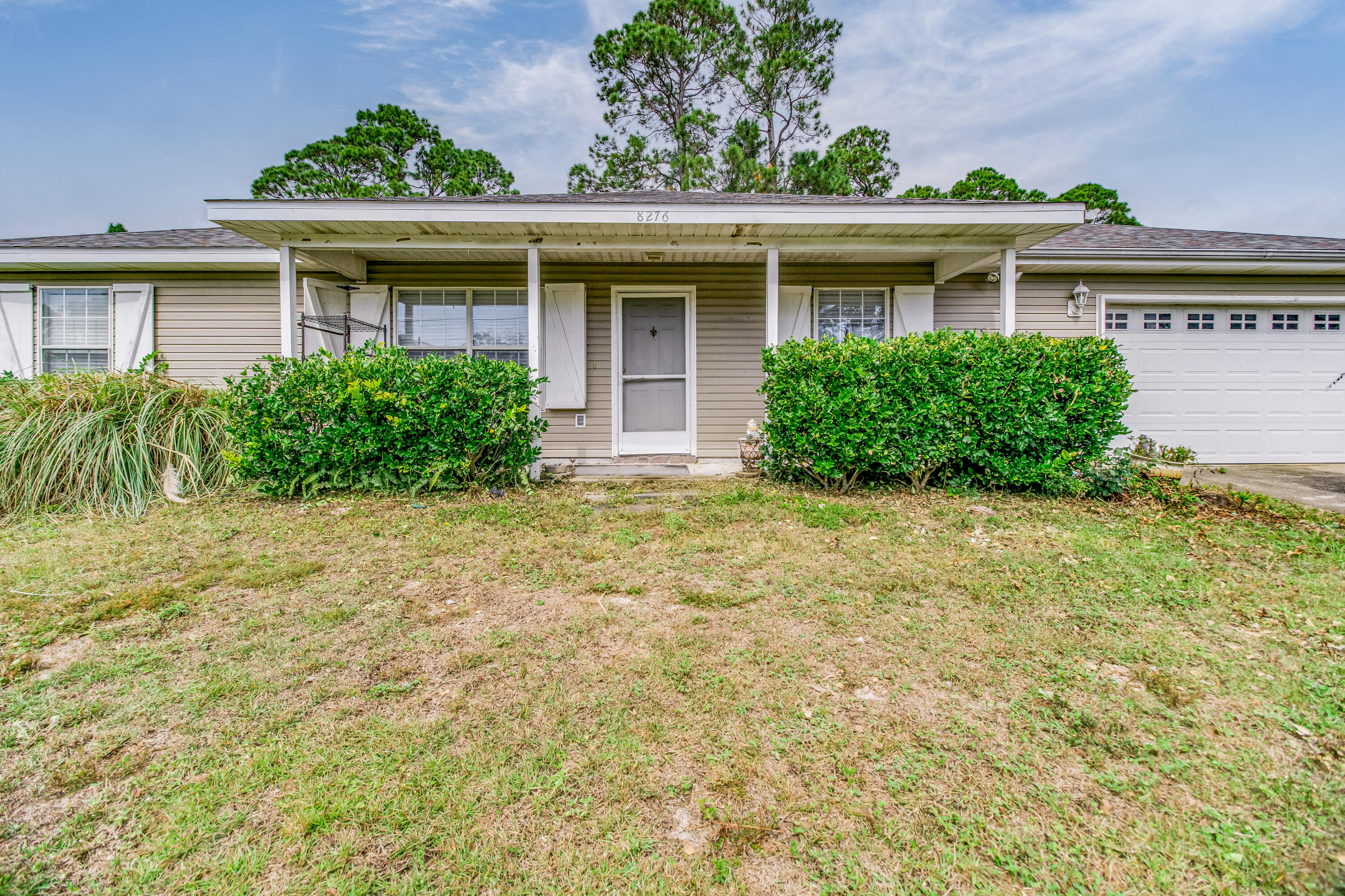 This home is ideally located in the central part of Navarre only minutes from schools, Publix, Wal-Mart, and the Navarre Beach bridge which takes you over to the beautiful white sandy beaches and emerald green waters of the Gulf of Mexico. This home offers the popular split bedroom floor plan with the master bedroom and bath on one side of the house and an additional two bedrooms on the other. The fourth bedroom is strategically placed off the kitchen and could easily be used as an office. Tasteful and low-maintenance tile flooring has been installed in all rooms for easy cleanup. Enjoy grilling and entertaining in the almost half-acre backyard.