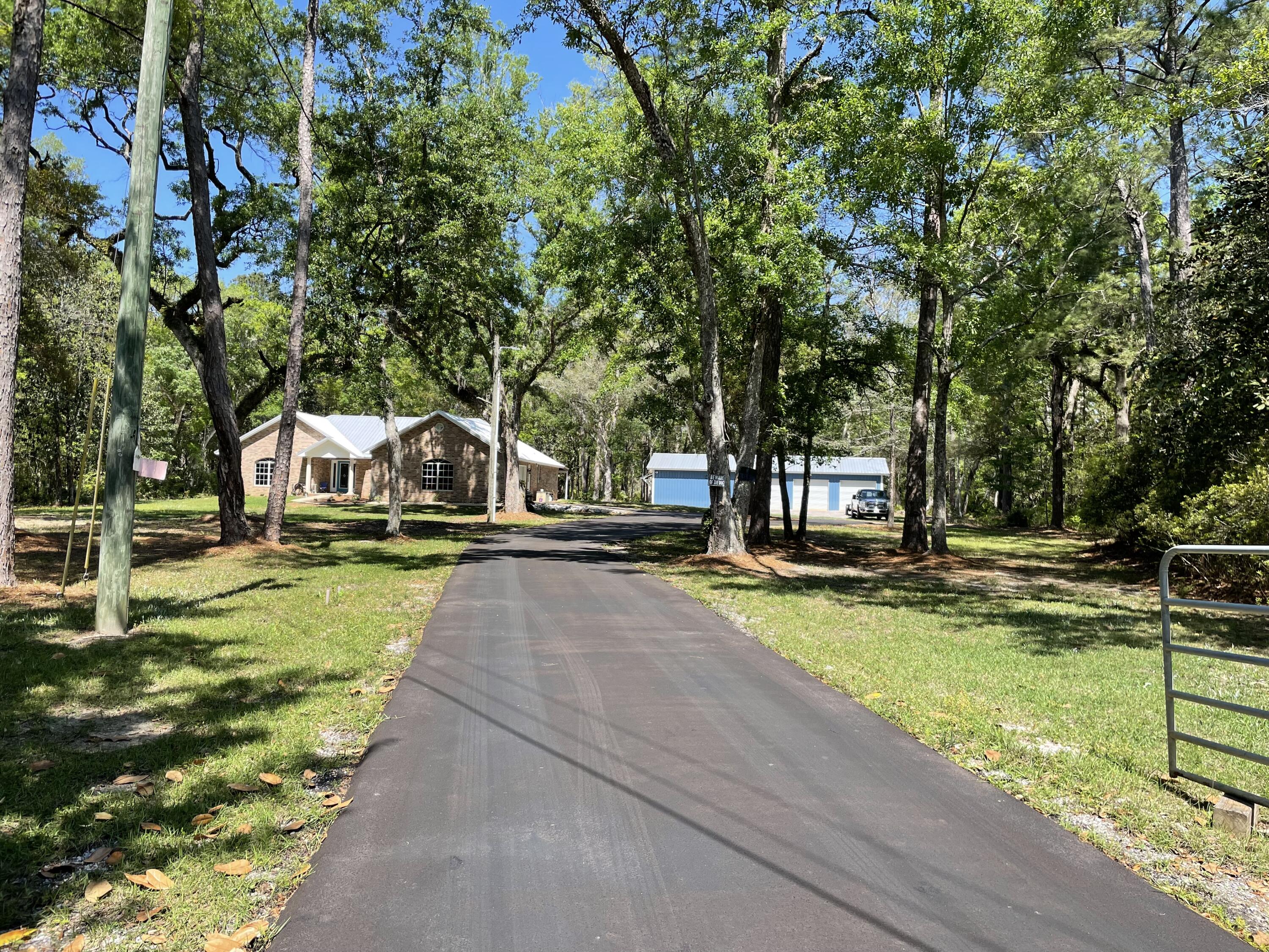 OPEN HOUSE May 20th 10 AM - 1 PM. 
As you drive down your private paved drive you will come to a renovated 3bedroom 2 bath home with oversized 2 car garage sitting on 2.66 acres. Home has an open floor plan that is perfect for entertaining. Just open the french doors in the living room to the extra-large screened porch. French doors in the Master bedroom lead to the open porch. The Master bath has his and her walk-in closets, a soaker tub, separate shower, double vanities and a water closet. With this property you will have plenty of extra parking in the new 24x60 workshop.
New items:  kitchen cabinets, granite countertops, appliances, paint, flooring, light fixtures, mirrors and screen porch installed 2021. New metal roof and shop 2022. Fridge 2023. Paved driveway installed 2023. No HOA's. Great location. This home is a must see.