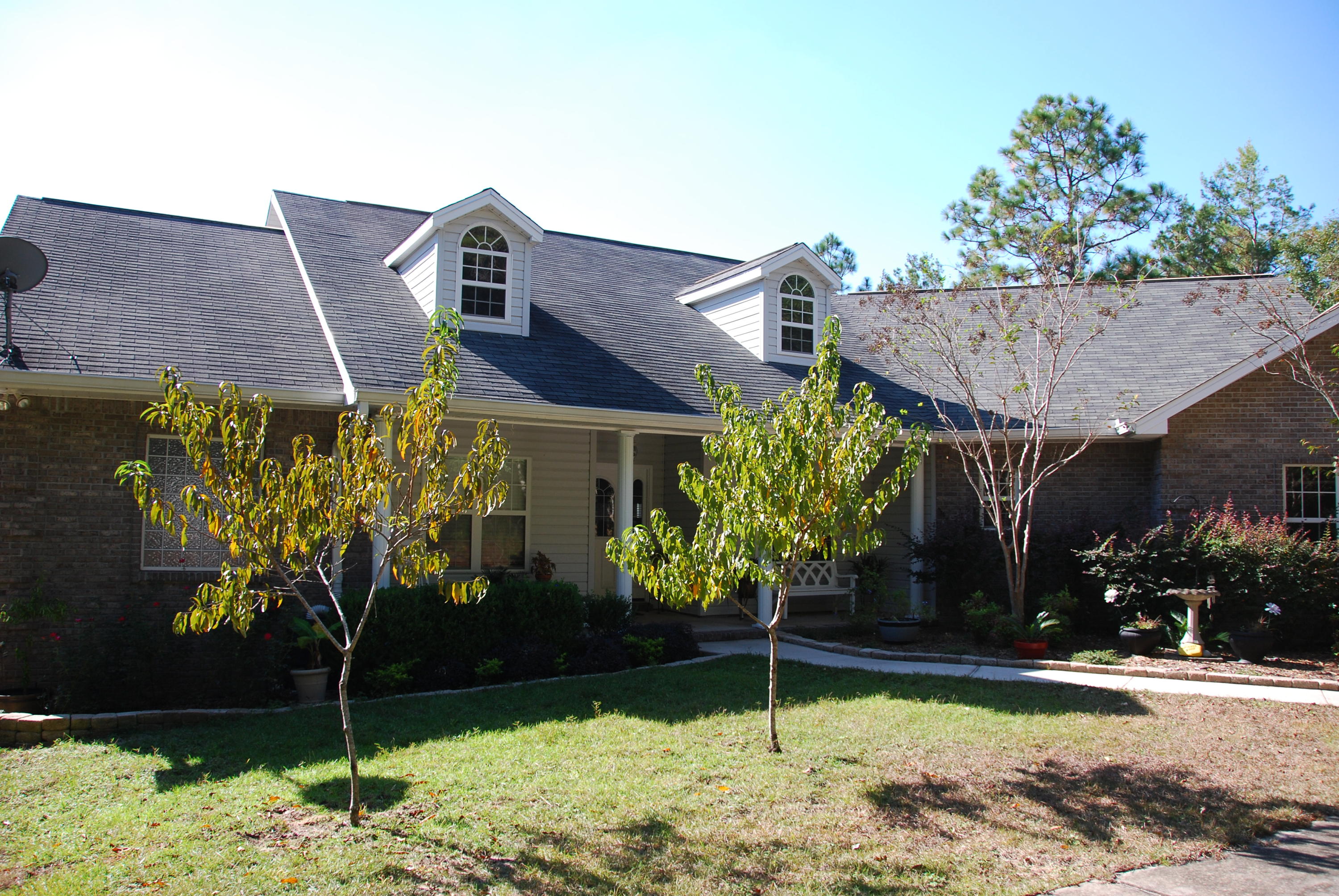 Calling ALL Motorheads and Craftsmen... Don't miss this house!! Oversized two car garage AND room for THREE cars in the downstairs workshop! This brick beauty is nestled on 4.45 acres in town! Plantation style front porch welcomes you into the open floor plan with bamboo and hardwood floors featuring formal dining, corner gas fireplace in great room opening to gorgeous kitchen, breakfast bar and nook. Study with built in bookshelves and beautiful master suite with trey ceiling. Two bedrooms and full bath all located on main floor. Downstairs, you will find an awesome open room (it is heated and cooled) with a bathroom perfect for all of your hobbies and entertaining! Screened porch, wooded acreage and private drive are just a few of the other extras with this house! Call to see it today!!