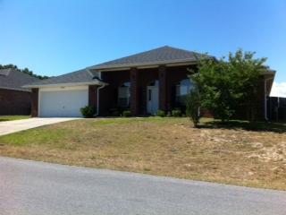 Absolutely gorgeous all brick home in the great community of Lee Farms! This elegantly appointed residence has a split bedroom plan featuring 4 bedrooms and two baths. It is actually a double split with the master bedroom being on one side of the home and the other three on the opposite side but one of those extra bedrooms is located on the opposite side of the great room from the other two. It makes a great study or guest room. The home has a formal living room and a formal dining room separated by a large foyer, plus a gigantic great-room with vaulted ceiling, plant shelves, and fireplace. Beautiful Berkshire cherry Pergo flooring and ceramic tile floors (carpeting in bedrooms). Gallo Napoleon granite counter-tops in kitchen with a black granite sink.