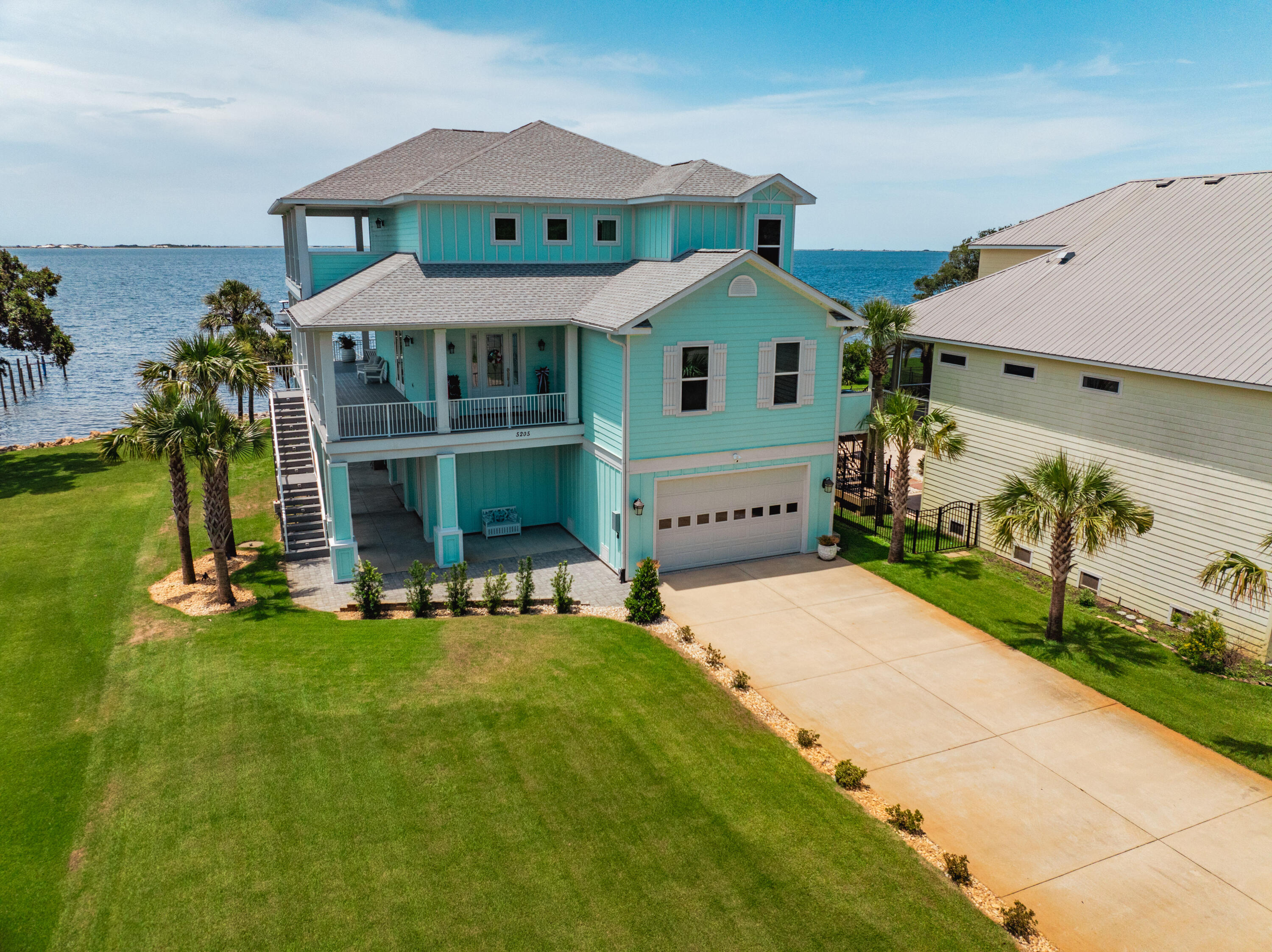 Welcome to this bright and sunny custom-built waterfront home, offering breathtaking panoramic views of the Santa Rosa Sound. Designed to maximize the beauty of its surroundings, this home features a main living area and kitchen with a wall of high-quality impact glass doors, ensuring stunning water views from every angle. The open kitchen is a chef's dream, featuring custom white cabinets that extend to the ceiling, an oversized walk-in pantry, and top-of-the-line stainless steel finish appliances, including a stainless oven, microwave, dishwasher, and a 36' gas range and refrigerator , large island with storage, vented range hood, under-cabinet lighting, recessed lights, and pendant lights complete this gourmet space. The countertops are adorned with beautiful "Fantasy Brown" dolomite quartz

The master bedroom offers gorgeous views of the sound and access to the rear wrap-around covered porch. It boasts a tray ceiling, two walk-in closets with custom drawers and shelving, a tiled walk-in shower with a frameless glass door, and a luxurious whirlpool tub. Two additional bedrooms on the third floor provide ample space for family or guests, one of which also has access to the rear covered porch and waterfront views. A fourth bedroom on main living area , A full bath is adjacent to bedroom #4, with an additional half bath in the main living area for guests.

Exterior amenities are truly exceptional: a 220' dock with Sure Step perforated decking, two boat lifts with 10,000# and 6,000# capacity, and water and electric connections. The property also includes a vinyl seawall, a main garage with polyurethane/epoxy-coated floors, a full shower bath, two built-in workbenches, water hookup for an extra refrigerator, and three doors with openers. Additionally, there's a detached cinder block workshop with a metal roof and three roll-up doors.

For deep-sea fishing, the Gulf of Mexico is just a short ride to the Pensacola Pass. To visit the beach, just boat across the sound to Opal Beach at the National Seashore, with pavilions and bathrooms, and walk across to the white sand and emerald green waters on the Gulf.

This home is equipped with a whole-house surge protector, two Carrier A/C heat pumps, a tankless gas water heater, an exterior 30 or 50 amp RV electrical panel, and a hydraulic elevator providing convenient access from the ground floor to the third floor.

Recent property improvements include:

New paint on all interior walls
New flooring throughout the home
Shiplap fireplace wall and main-level bedroom
Fireplace and shelving
Wood shelving in the pantry and upstairs storage closet
New refrigerator
Palm trees, Sylvester tree, and landscaping
Rido Rust system for the sprinkler system
New Tri-toon cradle
Installed fire pit area
Don't miss the chance to own this exquisite waterfront home with its unparalleled views and luxurious features. Schedule a viewing today and experience the best of Santa Rosa Sound living!