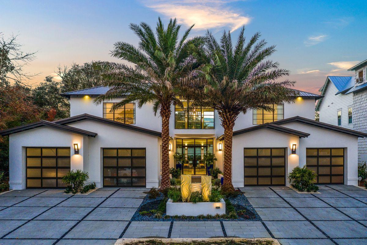 Striking contemporary architectural details juxtaposed finely appointed finishes and masterful insulated concrete construction define this rare compound property newly built in 2020 by Jeremy Trantina primely located in the heart of Seagrove Beach. The outstanding exterior facade is beautifully designed with ample symmetry featuring a four car garage with iconic glass doors flanking the tranquil entryway featuring custom designed steel windows and entry doors that characterize this modern marvel. The two story vertical footprint offers an extremely open living concept with a sprawling layout catering to entertaining guests as well as thoughtful seclusion for each bedroom suite which all feature their own bathroom as well as a private master wing on the first level for optimal comfort. Upon entry, the soaring double height ceiling and walls of floor to ceiling impact glass in the foyer and formal living room allow for exceptional natural lighting as well as a focused perspective overlooking the rear courtyard and private resort pool. The two story linear gas fireplace anchors the formal living space and is finished with a custom mosaic marble with tantalizing brass accents. Hand selected designer furnishings and window treatments are found throughout this well-curated home which convey with the sale of the property. The chef's kitchen is finely appointed highlighted by beautiful navy custom cabinetry as well as stunning quartz countertops with the latest Wolf and Subzero appliances as well as generous storage offerings including an LED lit display case as well as a scullery offering a prep station, organized food storage, coffee bar and a secondary refrigerator.

The rear lanai is a wonderous private retreat offering concrete walled privacy, an oversized resort style pool and adjoining spa separated by a massive linear gas fireplace which creates an unparalleled ambience while overlooking the beautifully manicured landscaping and lush planter pots. The rear courtyard is low maintenance and offers an outdoor kitchen area and 10' glass sliding doors that stack back into the wall on both sides of the pool for a complete open living and entertaining concept. Other notable features include modern glass safety railing inside and outside including along the custom built floating staircase, first floor master suite complete with floor to ceiling glass windows, two large walk-in closets, spa-like master bathroom with dual vanities, a walk in shower and a private water closet. The second floor offers three spacious guest suites as well as a private office which could also serve as another bedroom. The secondary living room upstairs is also set up to serve as an additional bedroom with built in bunk beds and a full ensuite bathroom. The second level also has a gorgeous outdoor veranda with glass railing overlooking the backyard oasis.

Seagrove Village is located in the heart of Old Seagrove Beach central to all of the world class shopping, dining and entertainment along 30A including easy access to Seaside town center, Watercolor and the public beaches of Seagrove which are only a block away from this prime location.