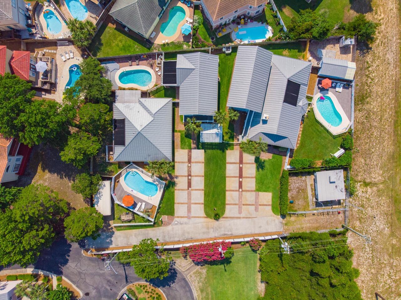 Control your financial future with this solid investment. Three established, turn-key vacation rental properties plus a one bedroom, one bath apartment. The Cabana's are located in Crystal Beach, a highly desirable area, and steps to the magical, sugar white sands of the Gulf of Mexico. The Cabana's is an investors dream opportunity.  This sprawling compound has an impressive selection of 4 properties. The Coral, the Banana, the Pineapple and the apartment.Each home comes with its very own private pool oasis, fenced in yards (pet friendly), paver lined driveway and comes with two street legal golf carts. Two, large public beach accesses Crab Trap and Pompano Joe's. The charming Coral Cabana is one level 3 bedrooms, 2 bathrooms with an open floor plan, tile floors and a covered wrap around porch to enjoy relaxing or reading. The Banana is located in the middle with 4 bedrooms and 3 bathrooms. All bedrooms on the 1st floor with a sprawling living space and kitchen upstairs. The cheery Pineapple Cabana is the largest of the three as a 5 bedroom, 3 bath home. This one-story home has plenty of room to spread out including a wrap-around covered porch. Attached but separate, is an upstairs one bedroom, one bathroom apartment with a fully equipped kitchen & family room plus washer and dryer. This would make a great office, retreat for an owner to stay at the beach anytime or lease it out long term. These homes are being sold furnished except for sheets and towels. All dimensions & measurements to be verified by Buyer. The Homes are being sold as-is, with right to inspect. See document section for floor plans and survey. All properties to be sold together, no exceptions. Enjoy the beach, biking, fishing or walking along the beautiful Emerald Coast. Centrally located to shopping, dining, entertainment and the BEACH make these homes even more of an exceptional value! These income producing properties offers exemplary value, and relaxed beach living the way life should be. Expand your portfolio with The Cabana's at Crystal Beach.