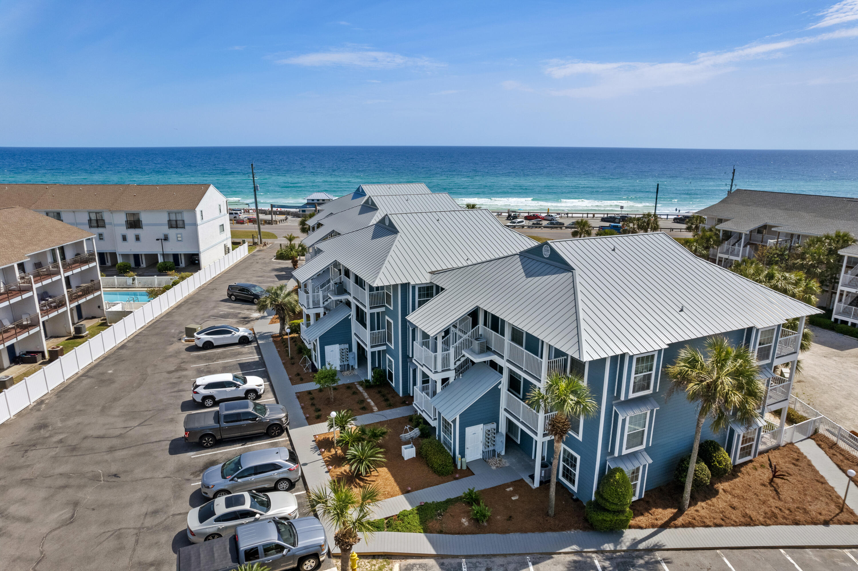 A Good Deal Just Got Better! Super Price For The Only Summer Breeze Condo Currently For Sale. This End Unit Has Extra Windows In LR & BR That You Do Not Get In Interior Units. Ground Floor Convenience, No Stairs or Elevators. And You Can Walk Out Back Door To Pool!  Kitchen Was Updated w/Granite Counters, Undermount Sink, White Appliances. Upgraded HVAC in 2024. Living Area Looks Out To Green Space. Always Popular Built In Hallway Bunk Beds w/ Pocket Door to Close Off From LR. Primary BR w/ King Bed & Bathroom Access. Sleeper Sofa in LR, Therefore Unit Sleeps 6. From Deck You Can See The Waves. Convenient Location Only Steps From Pool, Hot Tub, & Parking. Complex Is North Of Gulf-Front Miramar Park (which boasts Bathrooms & Pompano Joe's Seafood Restaurant). Easy Walk To Lunch, Happy Hour, & Dinner. Building Exterior Renovated in 2024 w/ New Pool Decking, Fencing, Balconies, Railings, etc. Call To Take A Look & You Might Want To Make This Your Place To Enjoy Refreshing Gulf Waters & Cool Sea-Breezes!!