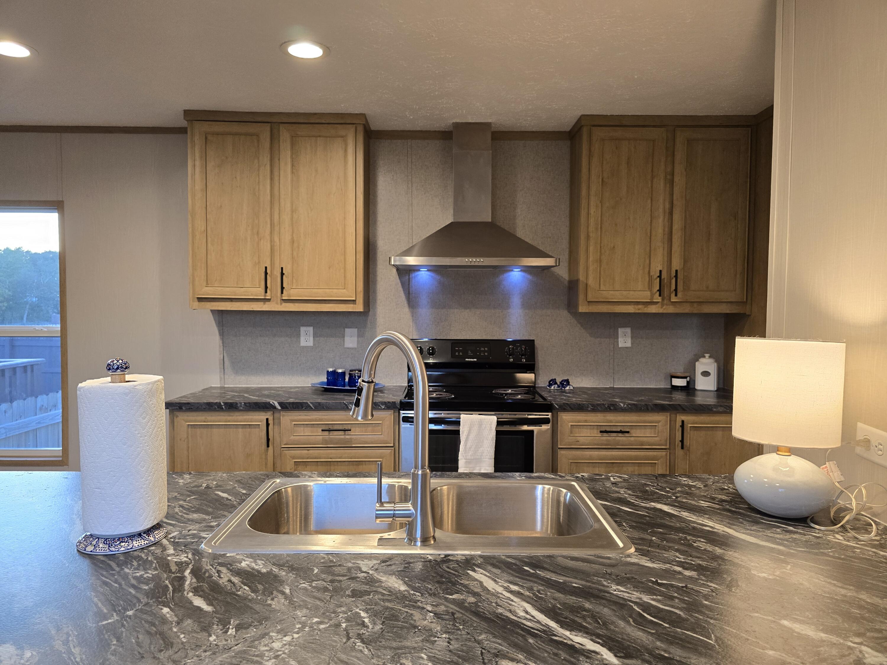 Welcome to this beautiful mobile home, Newly built in 2023! offering a perfect mix of style, comfort, and convenience. Located in a quiet and welcoming community, this property is designed for those who appreciate modern touches and easy access to some of Florida's top destinations.

Inside, you'll find durable and stylish LVP flooring throughout, paired with recessed lighting that creates a warm and inviting ambiance. The kitchen is a chef's dream, featuring stainless steel appliances, granite countertops, and ample cabinetry, making meal prep and entertaining a breeze.

The primary bedroom serves as a private retreat with its spacious layout, generous closet, and en-suite bathroom. Additional bedrooms provide flexibility for guests, a home office, or hobbies. Step outside to your own private oasis, a fully privacy-fenced backyard perfect for gardening, hosting BBQs, or simply relaxing in your personal sanctuary.

A unique opportunity awaits as the property next doora second mobile home with an identical floor plan and lotis also for sale. Whether you're looking for an investment property, a multi-family living arrangement, or a home for extended family, this dual offering provides endless possibilities.

Conveniently located just 7 miles from Interstate 10, this home offers easy access to nearby attractions. Pensacola, the scenic 30A beaches, and the crystal-clear waters of Morrison and Vortex Springs are all within an hour's drive. Whether you're seeking adventure or tranquility, it's all close by.

This modern home is move-in ready and waiting for you to make it your own. Schedule your private tour today!