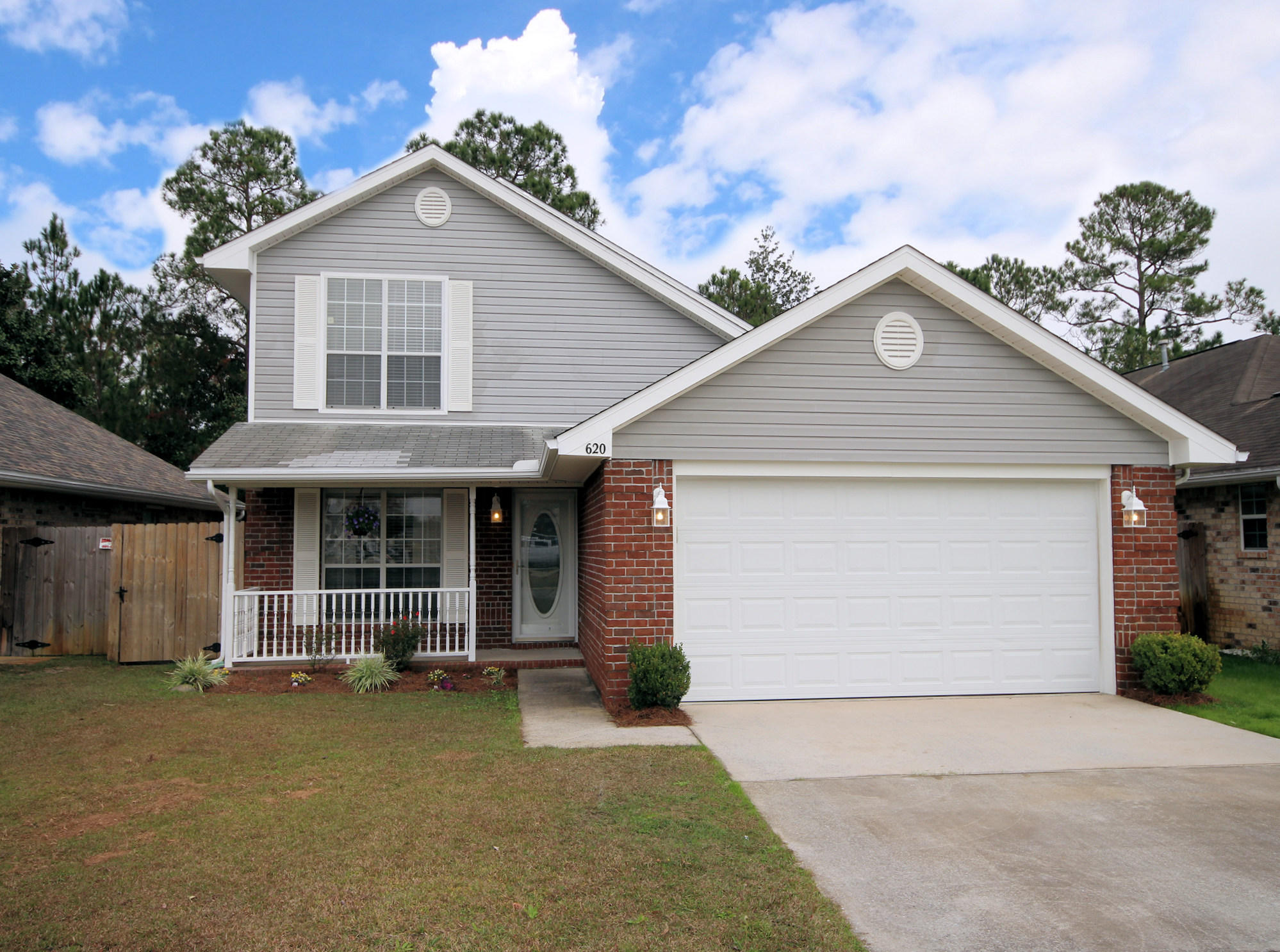 Turnkey freshly painted home located in desirable Emerald Village convenient to Hurlburt Field. Two story home features three bedrooms upstairs and Master ensuite on first floor. Gorgeous wood floors installed in living room with a professional Sony Bravia Home Theater Projector system, with in wall Polk Audio with large sub-woofer and a 106 professional screen. There is also a Vivint Home Alarm offering 3 web cameras with remote monitoring. Stainless steel appliances and breakfast bar complete the kitchen which is open to the dining area with ceramic tile floors for ease of maintenance. Whole house Rain Soft water softener. New HVAC in 2011. Upstairs bath features a Luxury Whirlpool Bath series tub by Jacuzzi. Please see feature sheet attached to listing for additional items. Screened in patio leads to privacy fenced back yard. Be sure to check out the large electronics storage area under the stairs accessible from door in kitchen.  Curb appeal greets you at the front door with covered porch.