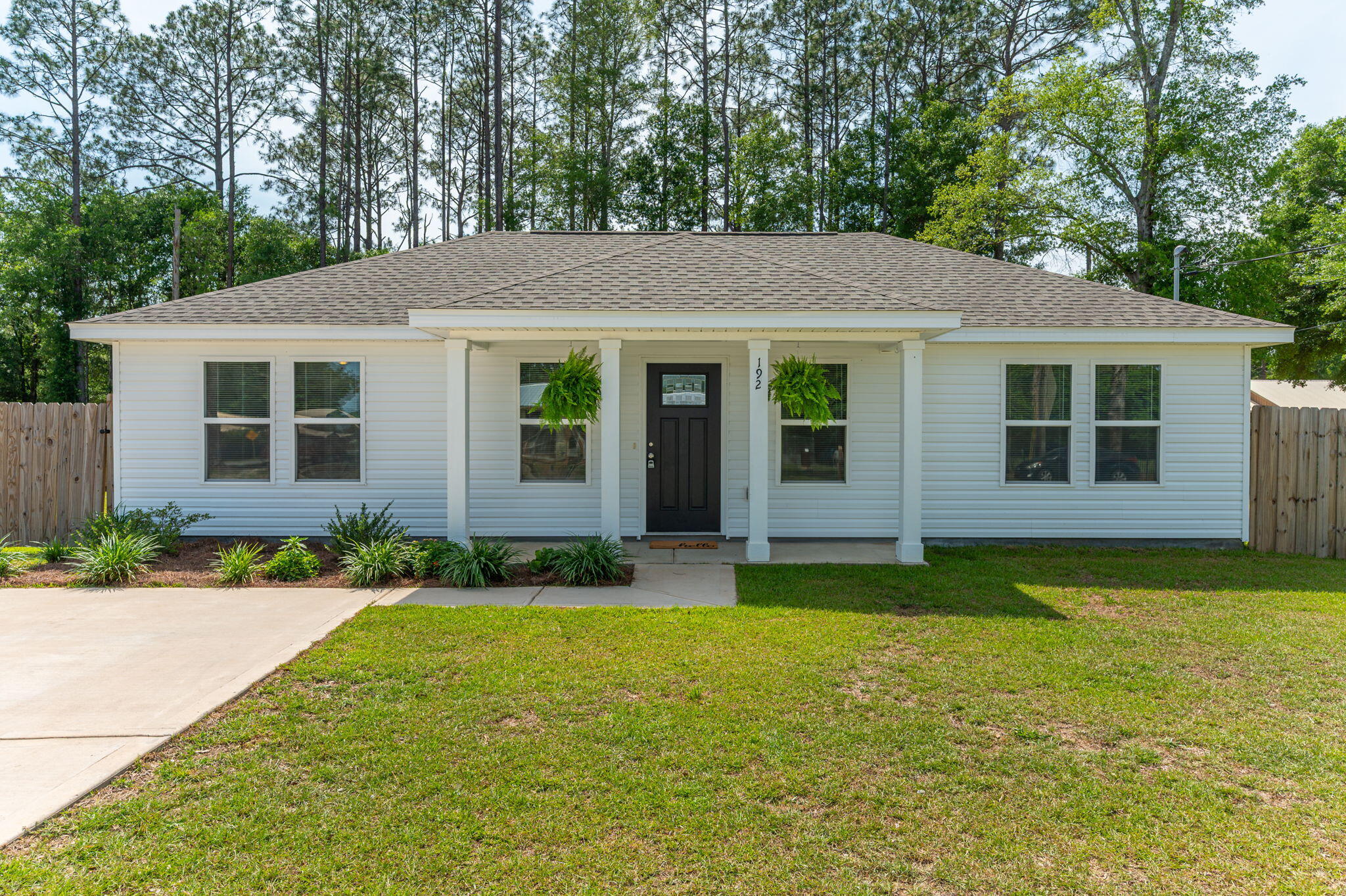 Welcome to this beautifully designed 3-bedroom, 2-bath home built in 2023, offering 1,056 sq ft of thoughtfully planned living space. Nestled on over a quarter-acre corner lot. Step inside to find a bright and open split floor plan featuring durable vinyl plank flooring in the living and wet areas, plush carpet in the bedrooms, and blinds throughout. The kitchen boasts stainless steel appliances, sleek quartz countertops, and timeless white shaker cabinets—perfect for both everyday living and entertaining. The fully fenced backyard offers privacy and space to play or garden, with a gated entrance for convenience. Located just 2 miles from historic downtown DeFuniak Springs, you'll enjoy easy access to shopping, dining, a local pharmacy, and more. Don't miss this move-in-ready gem!