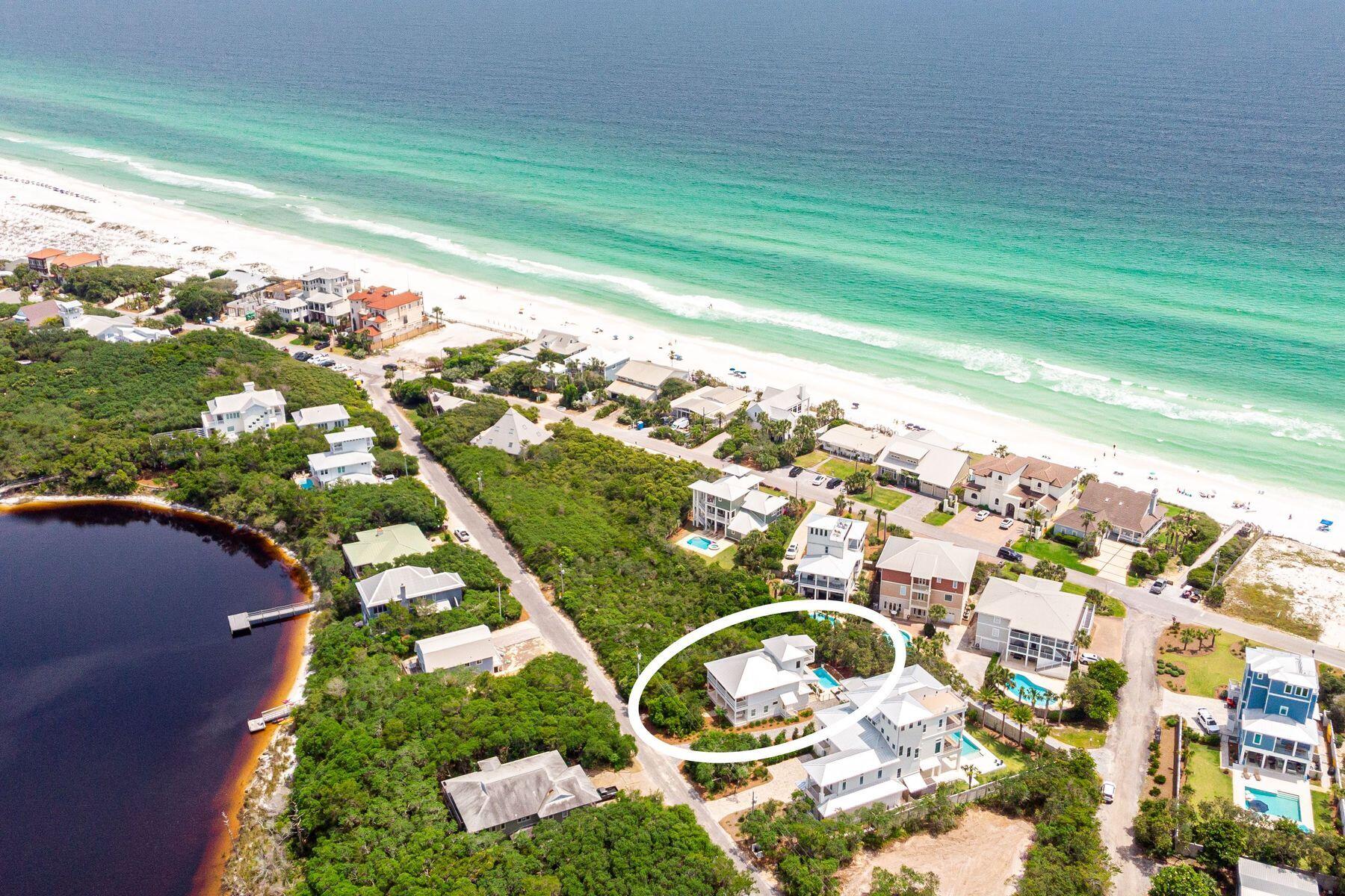 Located in the desirable Blue Mountain Beach community, this exquisite home epitomizes coastal living at its finest. With more than 1,100 square feet of inviting porches and situated on a generous quarter-acre lot, this residence is less than a block from beach access and features deeded access to Big Redfish Lake just across the street. This quintessential beach property seamlessly blends timeless elements with modern design. Completely renovated in 2017, the home was expanded by over 700 square feet and features a large swimming pool, one-car garage and golf cart garage. Boasting four bedrooms, three baths, and nearly 2,800 square feet of living space, the open-concept living area is adorned with hardwood floors, a built-in bookcase and abundant natural light from numerous windows. The kitchen is a chef's dream with granite countertops, a breakfast bar, wood cabinets, and a large, deep sink, making it perfect for entertaining. Never rented and offered furnished with some exclusions, this property is perfect as a true second home or a rental investment.