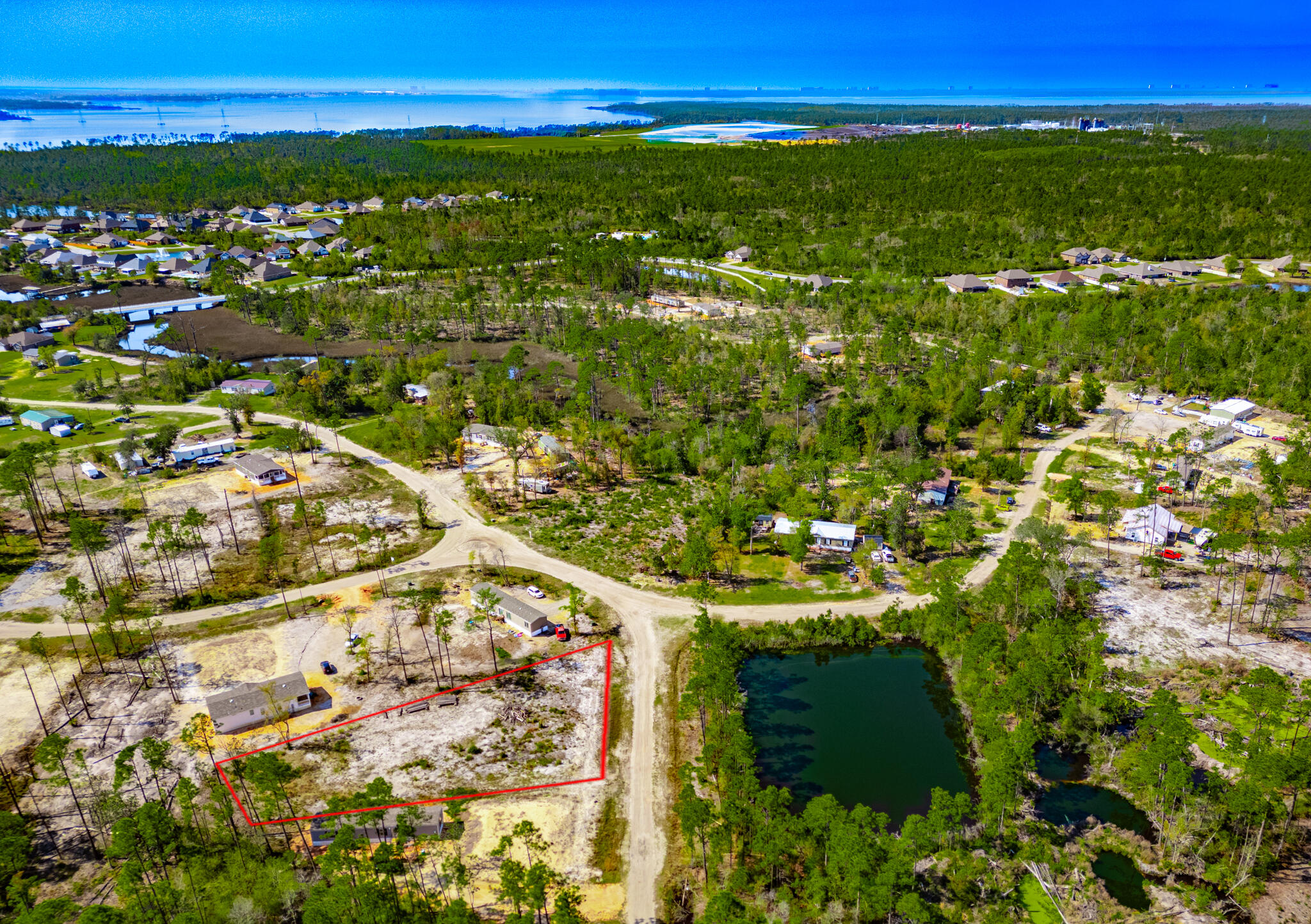 This .51 acre lot is ready for you to come build on. Sitting directly across from a large pond this site makes for the perfect place to to build your new home or set up your  manufactured home. If you position it just right you will be able to enjoy the view of that pond and some beautiful orange trees that are already thriving on the property. located less than a mile from a public boat ramp and fishing dock along with no restrictions against having boats, this location will be perfect for the fishing enthusiast.