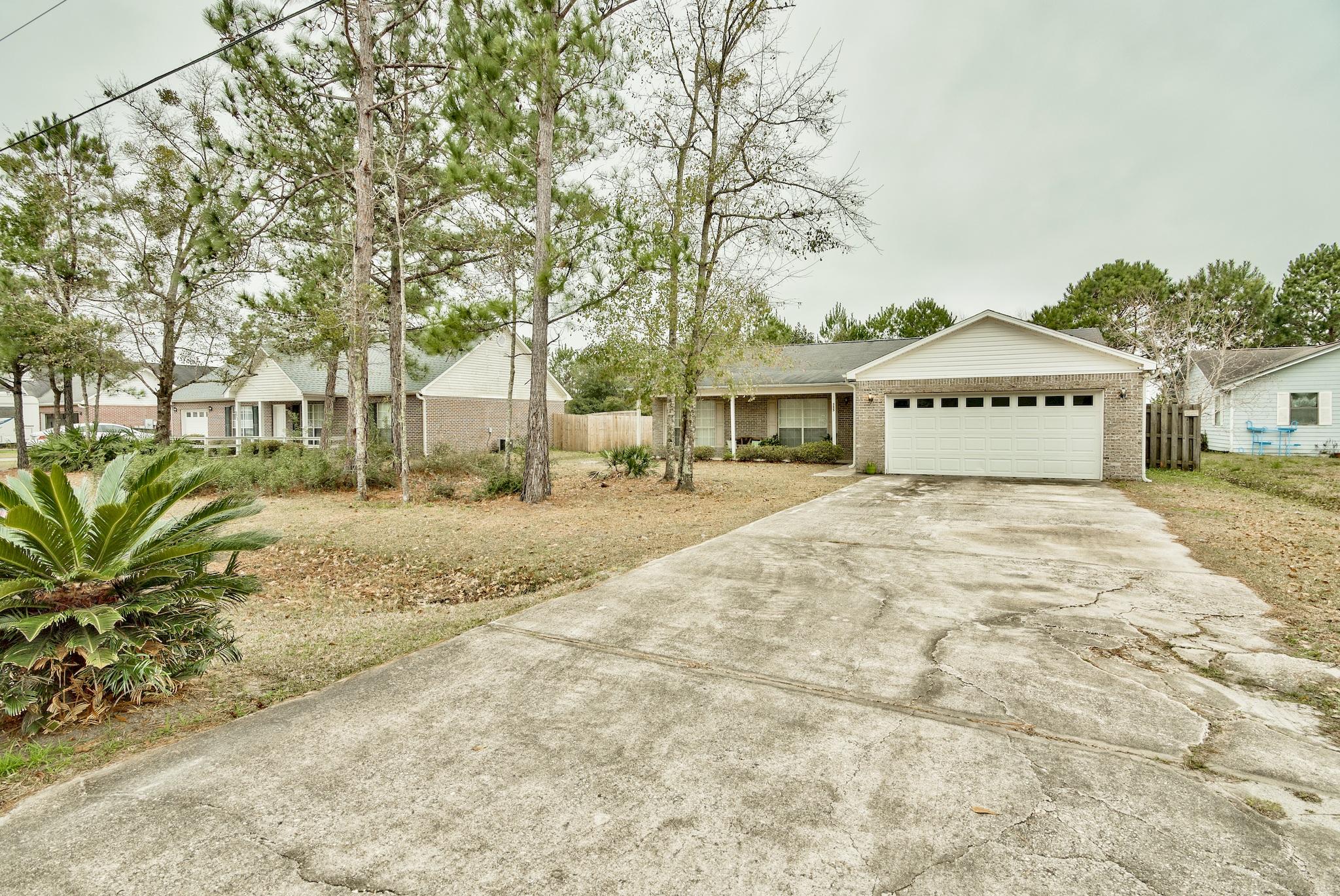 Built in 2004, this quaint 3 bedroom/2 bath home is located in the center of Freeport, Florida and boasts a traditional floorplan spanning 1530 sq. ft. A light, breezy color scheme of white, silvers and blues transition effortlessly from room to room; complimenting it's ambient light and high, peaked ceilings. The full kitchen is centered between a private-style dining room and dedicated office space. In addition to it's expansive size, the living room has quite the prized focal point- it's fireplace! Which is a rarity of this area and one of the two unique features found within this home. The other, and what we consider to be the true gem of this property, is it's impressive fenced-in backyard. Perfect for those with children and pets, or for entertaining on summer nights. With a predominantly untouched yard of this size, there's plenty of room for a possible garden, planted fruit trees or even an expanded patio. The choice is yours!