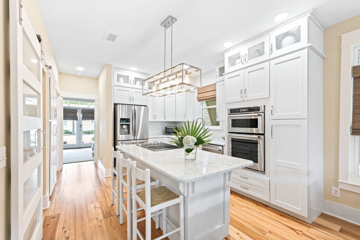 This beautifully maintained beach home features scenic gulf views from the third floor and is ideally located within walking distance of popular 30A beach communities and the Seacrest Beach amenities. Every whim is catered for in this spacious five-bedroom, fully furnished, vacation home, which includes two family rooms and two master suites - both with a private deck. Open main living areas feature beautiful hardwood flooring, and the kitchen offers granite countertops, stainless steel appliances, and a large island. Additional space includes a lower level bathroom and master bedroom.  On the first floor you will find an additional cozy living space with a custom convertible queen bed and full bathroom for the extra family or friends.