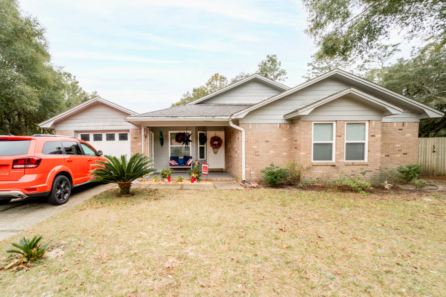 Tired of 2020 and ready to start the new year off right? When you enter this quaint home through the new front door and see the cozy fireplace, you will know this is the comfort and convenience that you've been longing for all year. This beautiful brick and Hardie board home features a picturesque fireplace,
brand new screened in porch, solid wood kitchen cabinets, stainless steel appliances, and (FINALLY!) a Bonus Room that can be the home office you've been needing all year! Not only is this a fantastic location south of I-10, this charming home is also located in a cul-de-sac in a safe neighborhood, features a home security system, and is surrounded by a wooden privacy fence built in 2018.  Behind
that privacy fence you will find the best thing for beating the Florida heat... an above-ground pool meticulously maintained and surrounded by a sturdy wood deck built in 2020! In 2019, the fireplace was
professionally swept, walls and cap were replaced, and the beautiful custom built doors were installed, literally and figuratively making this a warm and inviting place for everyone. The family and dining rooms have solid stone tiling, while the bonus room has luxury vinyl planks installed in 2020. All windows and exterior doors were replaced in 2020, garbage disposal in 2019, and the A/C coils were cleaned in 2019. The new 16-inch commodes are a pleasant feature and are easier on the hips, knees, and back than standard height commodes. If 2020 has you longing for something new, something fresh, comfy, and
convenient, then you have found the right home for you!