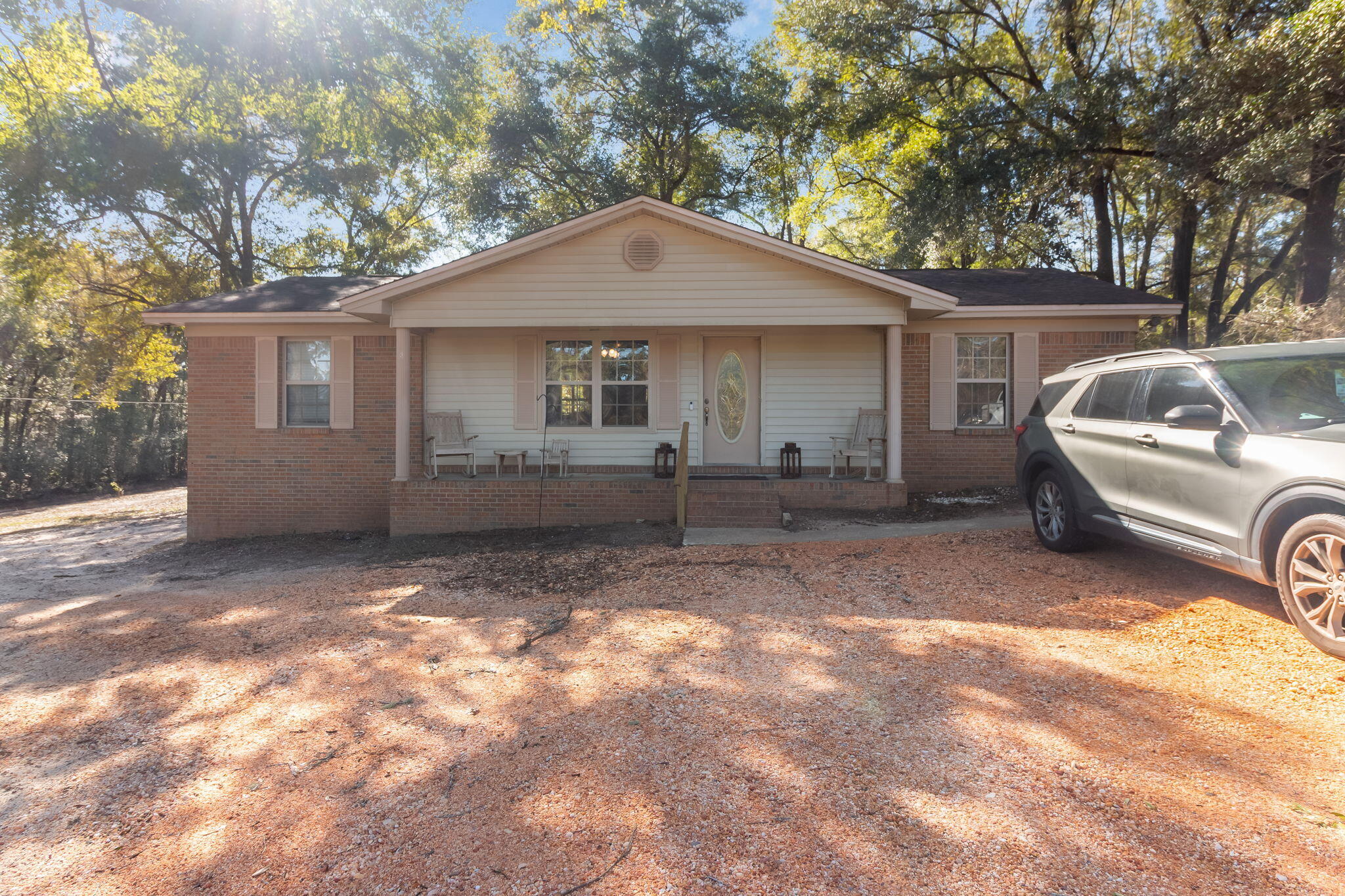 Welcome to this well-maintained 3-bedroom, 2-bath home offering the perfect blend of convenience and country charm. Situated on a full acre in Defuniak Springs, this home provides easy access to beaches, shopping, and everyday amenities while still delivering the peace and space of rural living. The bright, airy interior features an open floorplan ideal for both daily living and entertaining. Step outside and enjoy true outdoor living with a large covered back deck and a welcoming covered front patio, perfect for relaxing or hosting guests. The expansive backyard includes covered parking ideal for boats, vehicles, or equipment, along with a workshop that adds incredible functionality. With room to spread out, entertain, and enjoy the outdoors, this property is a rare find and a perfect place to call home.