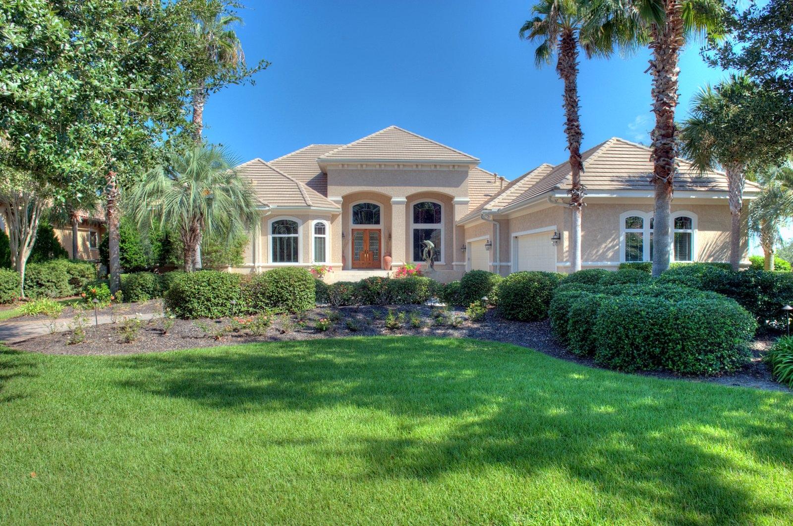 Significant price reduction! Motivated Seller says ''Bring us an offer!'' Stunning bayfront custom home in the desirable gated golf course community of Regatta Bay, meticulously designed and constructed with elegance, taste and comfort in mind. An impressive entrance foyer, with 16 foot ceilings, offer the first of many bayviews. Immediately to the right is the formal dining room, with trayed ceiling and faux finish. The living room is adjacent and features a custom Florida coral fireplace surround, trayed ceiling, recessed lighting and a large wet bar with wine cooler, ice maker, mounted cabinetry, antique brass hammered bar sink, marble top and room for several bar stools. The open kitchen/morning room/family room overlooks the lanai, pool and bay and is perfect for casual entertaining.  Every cook will love the kitchen, with beautiful granite counterand back splash, center island with new gas cooktop, downdraft, Bosche dishwasher, new Jennaire refrigerator, double ovens, warming drawer, built-in desk and a huge walk-in pantry.  The family room has a gas fireplace, also with a Florida coral surround, numerous niches with recessed lighting suitable for art and collections display, surround sound and sliding glass doors opening onto the lanai.  Luxurious master suite features a very spacious bedroom, two closets, large bath with walk-in shower, private water closet, double vanities, separate tub.  Floors in the main living areas are travertine, with carpet in the master and two guest bedrooms.  A third guest room is waterfront and has travertine floors, could be used as a hobby room, art studio or exercise room.  A handsome office/library has built in desk and bookcases.  Impact 3M film is on all windows, security system with extra sensors, security lighting, supplemental power system hooks up refrigerator/microwave and outlets to generator (not provided) during power outages.  Large screened lanai with pool and spa, summer kitchen with new gas grill.  Brick paver circular driveway and back walkway to dock and boathouse (with tiled roof and 10,000 lb. lift).  Additional storage space in floored, sheet rocked, carpeted, heated and cooled attic.  Finely appointed throughout with raised ceilings, recessed and art lighting, travertine floors, crown molding, beautiful designer lighting, custom window treatments and more!  Bay front living at it's best1  This is a must see for the discriminating buyer.   Dining room chandelier and breakfast room chandelier do not convey.
