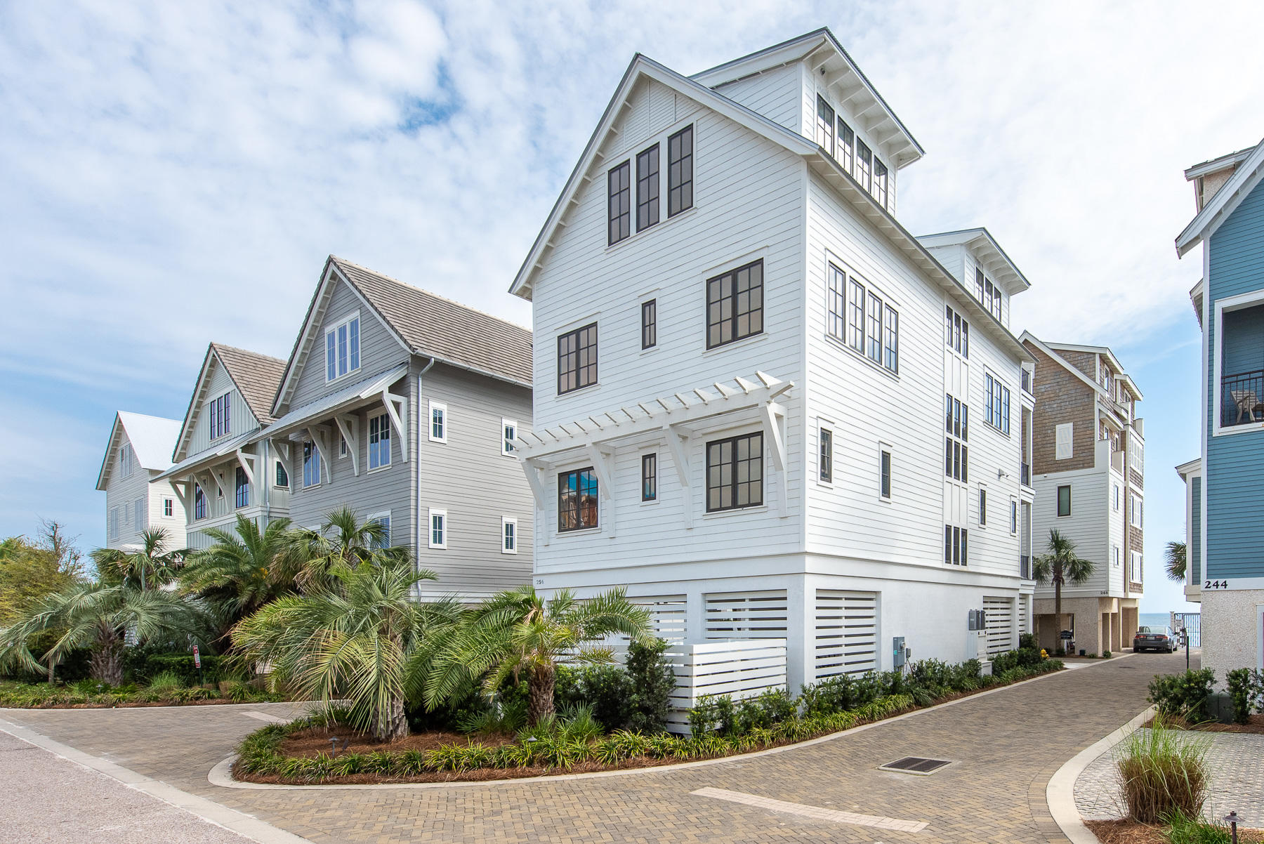 This stunning Inlet Beach home is one of the few exclusive homes located in The Bluffs. Desirably situated one home off the Gulf of Mexico and just east of Rosemary Beach. There is ample room for entertaining in this 6 bedroom 6.5 bath beach paradise. The 1st floor offers an outdoor loggia/patio featuring dining, shower, washer/dryer, and  bathroom. You are steps away from the beachfront community pool and 240' of private beach access. An elevator on the first level is a wonderful convenience to access 3 floors of this impressive home.
The 2nd floor offers three beautifully appointed guest bedrooms. The first bedroom features a luxurious king bed and a private bathroom with a shower/tub combo. The 2nd bedroom offers a king bed and private bathroom with a shower and separate soaking tub. The third bedroom on the 1st level offers two queen beds and a private bathroom with a shower/tub combo.
The 3rd floor of the home features the main living space and an open-concept floor plan with adjoining dining, kitchen, and living room areas. The gourmet chef's kitchen features white cabinets, marble counter tops, and top-of-the-line stainless steel appliances. The dining area offers seating for eight, and the adjacent kitchen island provide additional seating for four. Relax in the living room area with plush furnishings and a soft, neutral décor palette. A wall of pocket sliding-glass doors leads to the third-floor balcony where guests can relax on the swing and enjoy views of the Gulf. Completing the third floor is a delightful bunk room featuring two sets of built-in twin bunk beds and a shared bathroom with a shower/tub combo.
The 4th floor encompasses the stunning master suite with a luxurious king bed, a comfortable sitting area, walk-in closet, shiplap walls, a high vaulted shiplap ceiling, and french doors that allow the sunlight to pour over the suite. The spa-like private en-suite bathroom offers a gorgeous soaking tub, a large dual-sink marble vanity, and a separate glass-front shower. Relax and enjoy views of the emerald waters from the master suite's private balcony.