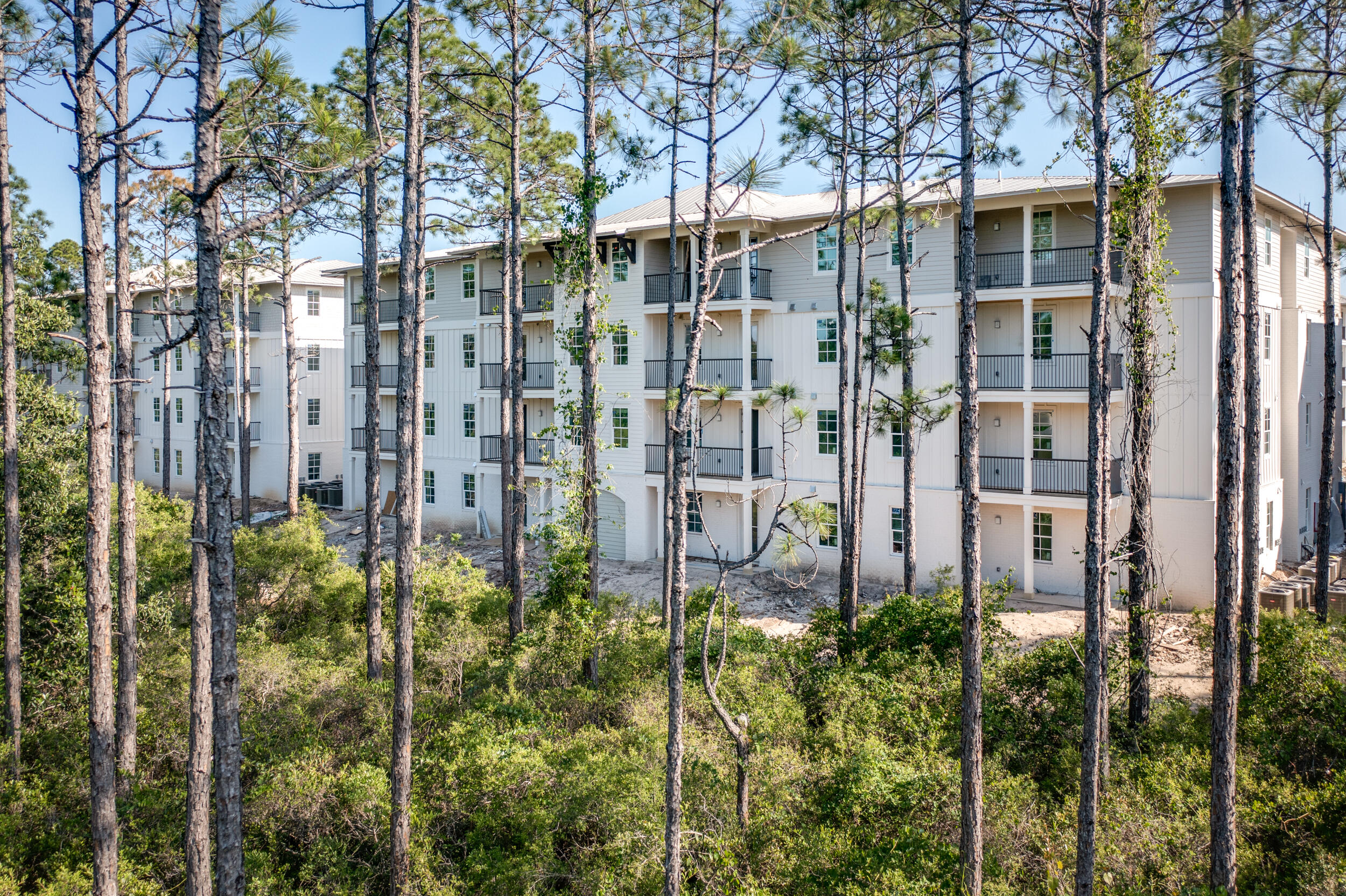 Introducing Pinewood 30A, a brand new South Walton community, offering the perfect combination of luxury and convenience. Tucked away amongst the beautiful Point Washington State Forest and just a short bike ride to white sand beaches. This 2 bedroom, 2 bathroom condominium is the ultimate getaway into the 30A lifestyle. Luxury features include quartz countertops, stainless GE energy star appliances, luxury vinyl + tile flooring, large walk-in closets with custom wood shelving, 9' ceilings, 8' solid core doors, private covered porches + more!  Pinewood 30A provides residents a sense of quietude by using R30 Mid-Floor Density Insulation, an acoustic mat membrane to reduce sound transfer between floors.  Amenities at Pinewood will include two pools, one being a heated, zero entry clubhouse pool, hot tub, firepit, professional center with comfortable work space, fitness center, indoor/outdoor dining options including an upscale restaurant and a general store + coffee shop, + more to come! Optional assigned covered parking will be available at an additional expense.