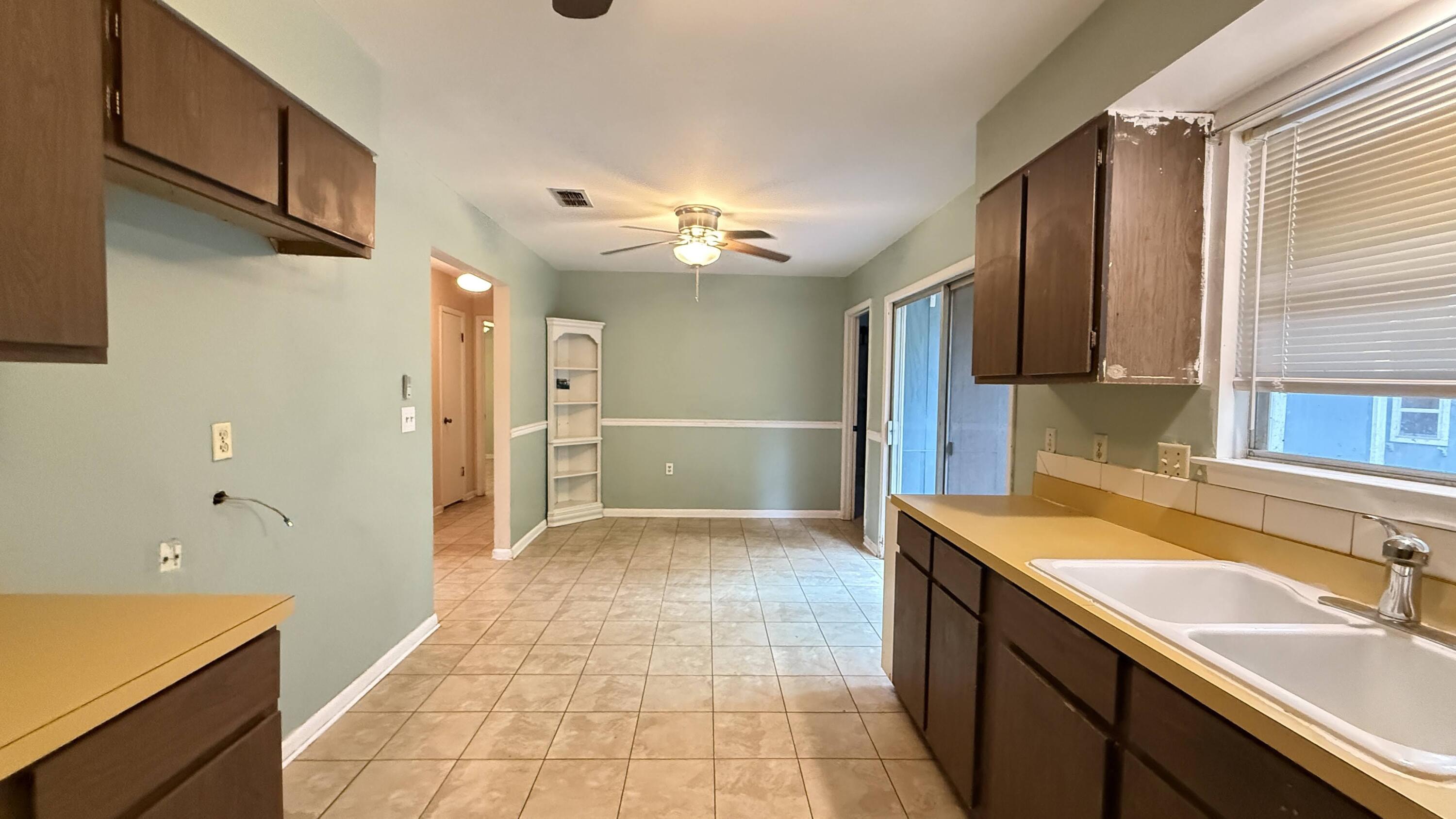 Perfectly located, this charming 3-bedroom, 2-bath home offers 1,362 sq. ft. of opportunity! Property is ready for your personal touch. Featuring a metal roof (2008), Hot water heater (2005) a brick front façade with freshly repaired/painted T-111 wood siding, covered front porch perfect for relaxing. The open back deck and yard building offer additional space for outdoor enjoyment. Inside, you'll find a cozy living room, eat-in kitchen, and a bonus room/Flex space. The hall bathroom includes a tub-shower combo, while the primary bedroom features a barn door and a walk-in shower. This home is priced to reflect its potential. Seller offering a $500 Home Warranty  Don't miss this chance to create your dream space—schedule your showing  Today!