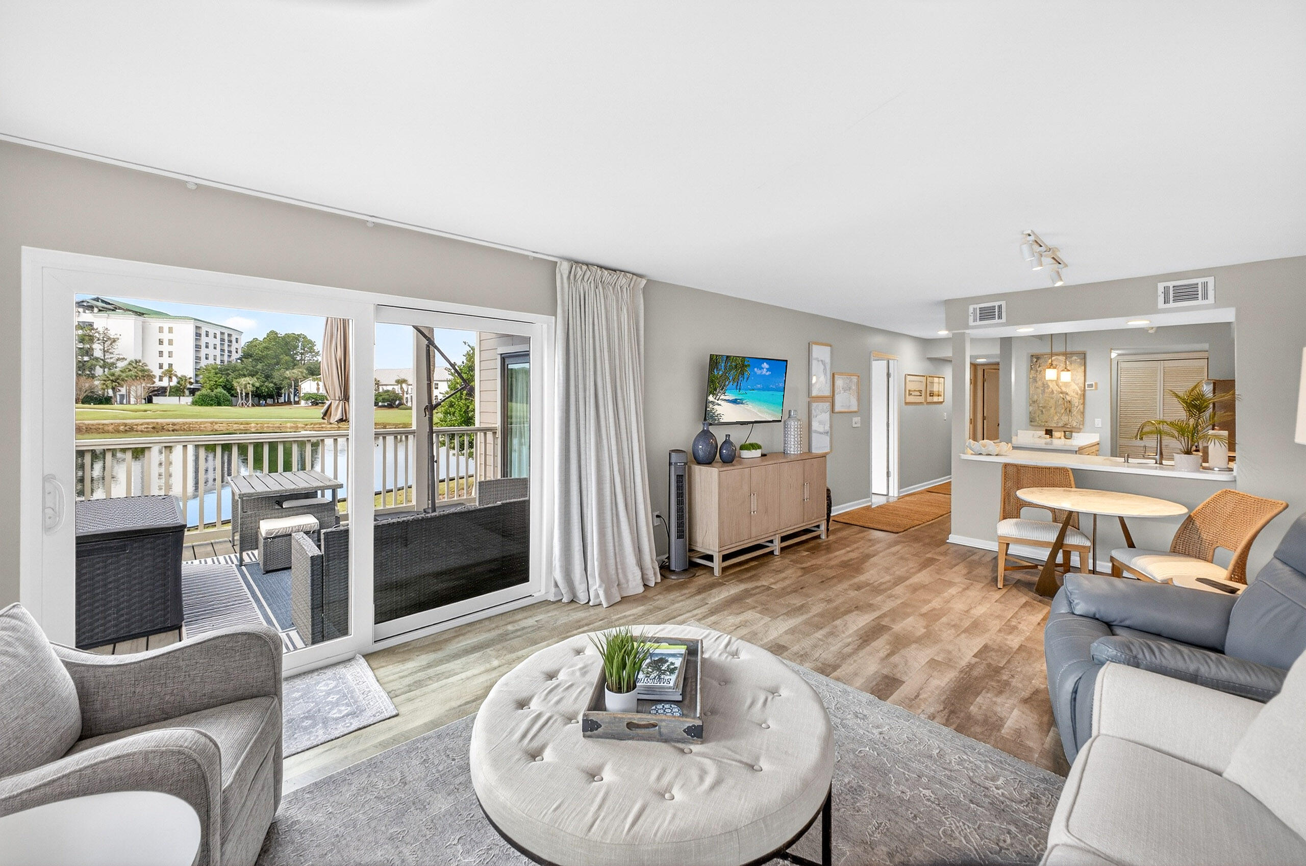 What a view! This1st floor, end-unit condo on the lake offers breathtaking wraparound water, and golf course views that immediately capture your attention the moment you step inside. These stunning views can be enjoyed from the main living area, the primary suite, and the expansive balcony. This beautifully renovated 2BR/2BA residence is truly turn-key and rental ready, featuring brand-new furnishings, stylish coastal décor, and light, neutral finishes throughout. Both bedrooms are generously sized with updated bathrooms, creating a space that feels airy, elegant, and inviting. Notable upgrades include new windows and sliding glass doors (approximately $13,000), and a new glass front walk-in shower in the primary bath (approximately $5,000), Exterior improvements at Harbour Point include new decks, railings, stairs, sliding doors, and windows, enhancing both beauty and value. 

As an introduction to the Sandestin lifestyle, we invite our new owners to explore amenities that make Sandestin special. The listing brokerage and seller(s) are presenting the buyer(s) of this property with (2) 90-minute rounds of Tennis court time, a golf foursome at one of our three championship courses, and a round of golf for up to four (4) players at the unrivaled Burnt Pine Golf Club.

Sandestin Golf and Beach Resort features more than seven miles of beaches and pristine bay front, four championship golf courses, 15 world-class tennis courts, a 226-slip marina, a fitness center, spa and celebrity chef dining. Shop, dine and play at the charming pedestrian village, The Village of Baytowne Wharf and more. Inside the gates of the resort, residents enjoy a balanced lifestyle of high-class living, spanning the 2,400 acres from the beach to the bay. Everything within the gates of the resort is accessible by golf cart or bicycle. The entire resort is interconnected by miles of pedestrian, bike and golf cart paths that weave through groves of live oaks, meandering past natural lagoons, fountains, man-made lakes, and meticulously landscaped fairways.
