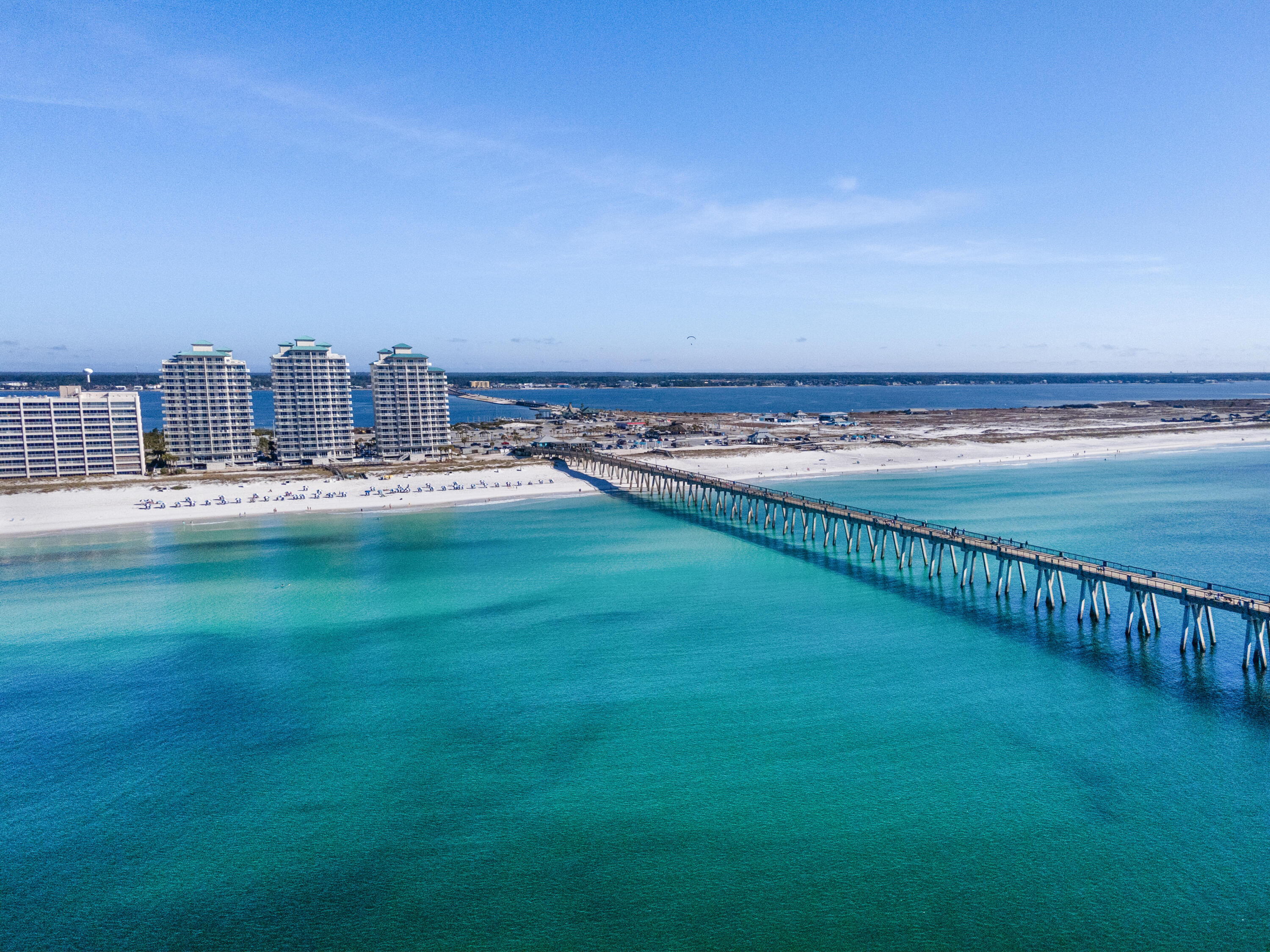 Experience the height of coastal luxury with this 16th floor penthouse unit at the Gulf-front Summerwind Resort on Navarre Beach! As a top floor residence, this unit offers unparalleled, panoramic views of the Emerald waters of Navarre Beach. Complete with an expansive, wrap-around rooftop balcony that is a true extension of your living space for catching the most amazing sunrise/sunset views while relaxing or dining al fresco. Inside, you'll discover high ceilings with a classic crown molding for an elegant touch. Featuring a split floor plan with 2 bedrooms, 2 full bathrooms, and a bunk room. The updated kitchen looks out over the breakfast bar to the dining room and living area - all with a breathtaking view of the water through the floor to ceiling windows and slider door. The primary suite is just off of the living room. Featuring its own access to the wrap around balcony, oversized closet, and full ensuite bathroom. This unit also includes its own deeded parking space. Plus, enjoy all of the amenities Summerwind Resort has to offer - including 3 pools - 1 of which is heated, hot tubs, BBQ grills, private beach access, Beach chair service, exercise room, and more! All while being one of the closest buildings to the Navarre Beach Fishing Pier. Everything "Navarre Beach" is practically at your doorstep!