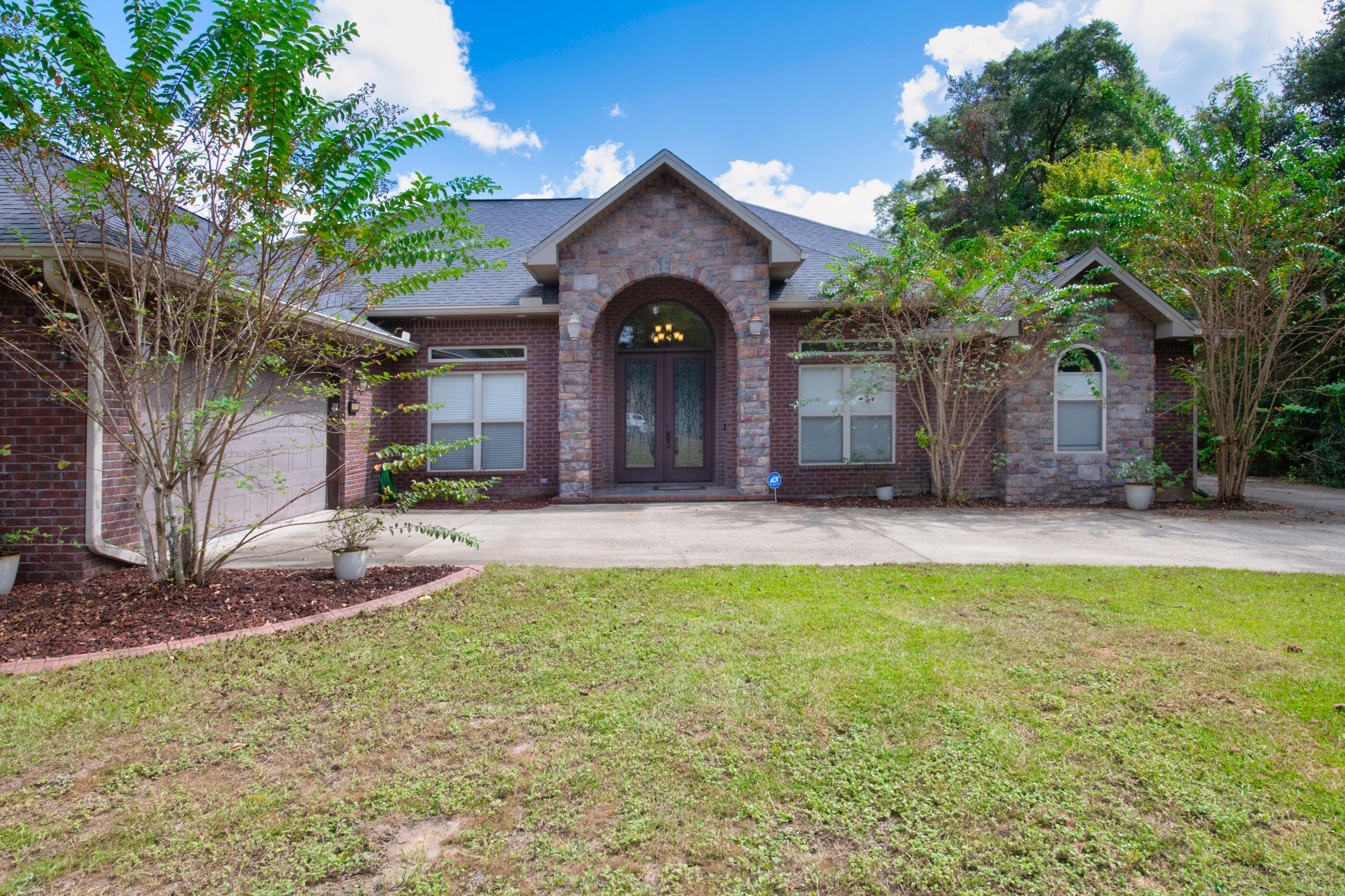 Accepting backup offers. Contract in place. Step into this beautiful custom-built home with 4 bedrooms and 2 ½ bathrooms situated on over 11 acres.  The grand front doors open into the foyer and a view of the dining room. Living room has beautiful coffered ceiling and engineered hardwood floors throughout all living areas.  Bathrooms and laundry area have tiled floors. Open the French doors from the living room to the covered patio, summer kitchen and enclosed pool. Pool is heated with solar panels. Summer kitchen has grill, sink and refrigerator, great for entertaining.  Home also has a privacy fenced back yard.  The kitchen has stainless steel appliances which include gas range with double ovens, microwave, dishwasher and refrigerator with ice maker. Quartz countertops completes this kitchen. Enjoy your huge master bedroom with access to the pool. Large master bath has spacious separate tile shower with glass doors, garden tub, double vanity and private toilet area. Master bath also has a huge 15x13 master walk in closet. There are 3 other bedrooms, along with a Jack and Jill full bath. There is a half bath with access to the pool area, so no swimmer has to walk thru the home. This home has 2 HVAC units for each side of the home. The laundry room has sink, cabinets and built-in ironing board. Oversized garage with key pad entry. Home has a security system. This home also has Mani block plumbing system. With 11 acres, you can even hunt from your back yard. Don't let this gorgeous home pass you by.