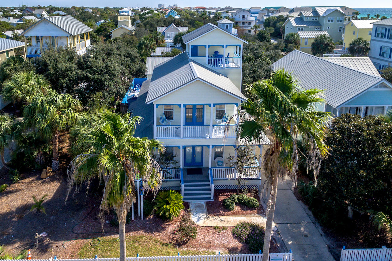 Welcome to Swedish Fish, a beachy getaway in the heart of Crystal Beach that truly evokes the feeling of living the island life! The bright coastal design of Swedish Fish, both inside and out, is sure to take you on a fantastic island vacation. The 3-story main home with 10-ft ceilings throughout, plus the detached fully finished carraige house in the back, offer a total of 5 bedrooms and 4 bathrooms, sleeping 12 guests comfortably in island style. The first floor features an open concept kitchen/dining/living room space with beautiful hand painted hardwood floors, and a bonus kids area or computer space with custom built-in painted cabinets. The bright sunny kitchen features factory custom colored cabinetry with crown moldings, granite countertops, and stainless steel appliances. Also on the first floor are 2 spacious guest bedrooms, 1 full bath, and laundry room. On the 2nd floor you will find the large master bedroom with ensuite bathroom, an additional guest bedroom with custom built-in bunks, and 1 full bathroom with walk-in shower. The master suite offers plenty of natural light  and french doors to a covered balcony. Just up the stairs to the 3rd floor you step out onto a large covered sitting area overlooking the beautiful Crystal Beach community with a slice of gulf view, the perfect space to kick back and relax morning or night. The back yard has an in-ground pool surrounded by Trex decking, with designer outdoor furniture, custom private outdoor shower, and painted privacy fence to complement the exterior of the home, all surrounded by lush green Florida foliage providing a secluded relaxing tropical environment. Across the pool area is the detached carraige house, complete with a full eat-in kitchenette open to the living area. The carriage house has 1 bedroom, a spacious full bathroom with shower and laundry area, and 2nd story loft with 2 additional beds.