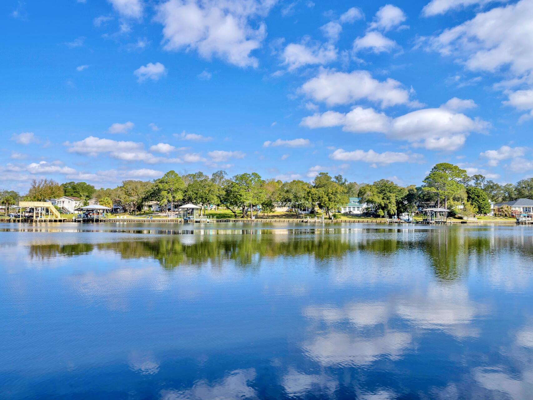 Waterfront property with nearly 6,000 sq. ft. of living space in a prime location less than two miles from Highway 98. Situated in a neighborhood at the end of the street, this home offers the perfect combination of privacy and convenience with easy access to local shopping centers. Enjoy direct deep-water dock access to the bayou, with a short boat ride to Destin Harbor and Crab Island, making this property ideal for water enthusiasts. The spacious Florida room is truly jaw-dropping, featuring floor-to-ceiling windows that flood the space with natural light and provide stunning panoramic views of the bayou. Generously sized front drive creates perfect for multiple cars. The recent price drop gives buyers room to make any desired upgrades. The seller is motivated—please submit all offers