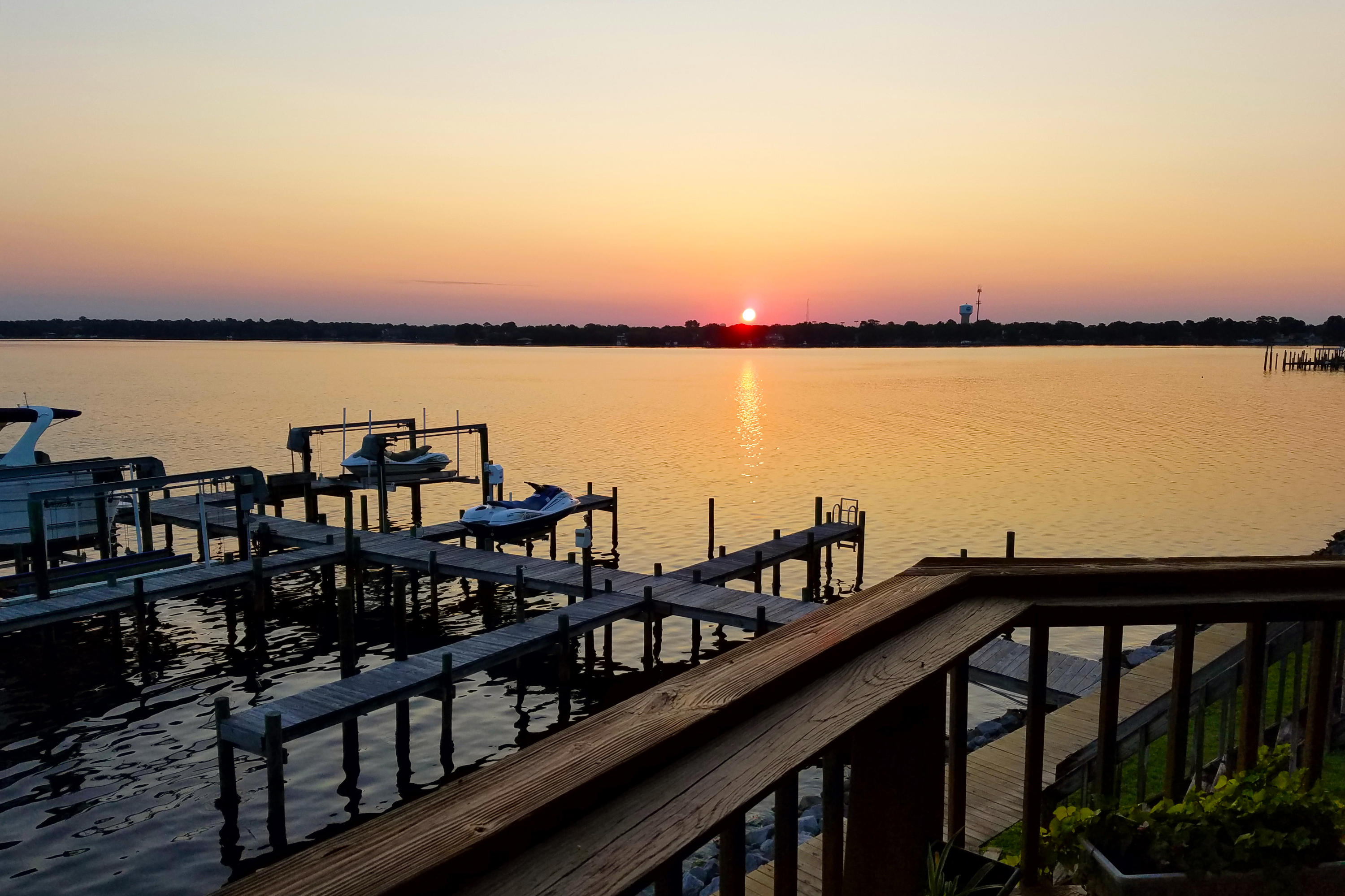 THE place for beautiful sunsets for years to come! This delightful townhome puts you just steps from your boat. Unit comes with a slip and boat lift. Two large custom decks and pretty landscaping. Generous Master Suite with garden tub. Additional kitchenette on first floor. Third bedroom could be used for an office area. You'll fall in love with the peaceful views of Garnier's Bayou! Don't pass up the chance for waterfront living at a budget friendly price! Please note: Only Small dogs and cats are allowable.