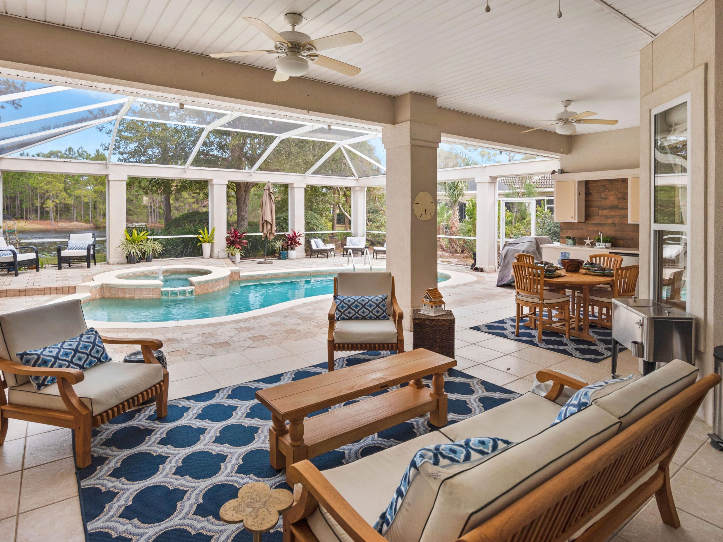 Situated within the gated community of Regatta Bay, this spacious lakeside property provides a wonderful layout, ideal for primary living as well as for those looking for a secondary home in one of Destin's most desirable neighborhoods. The interior of the home showcases a blend of tile and hardwood flooring in the living spaces, while additional features such as a formal dining room, home office, and open floor plan offer the perfect mix of traditional styling with modern day conveniences. Vaulted ceilings, a two-car plus golf cart garage, and a freshly painted interior creates a desirable coastal atmosphere within the property. The outdoor spaces are an entertainer's dream with a fully screened-in lanai featuring a beautiful pool with overflow spa, al fresco dining with adjacent wet bar, custom paver sunning deck, and enchanting views backing up to the lake. Regatta Bay provides contemporary living with elegant coastal amenities such as on-site golf, a community pool, clubhouse dining and full-time security.