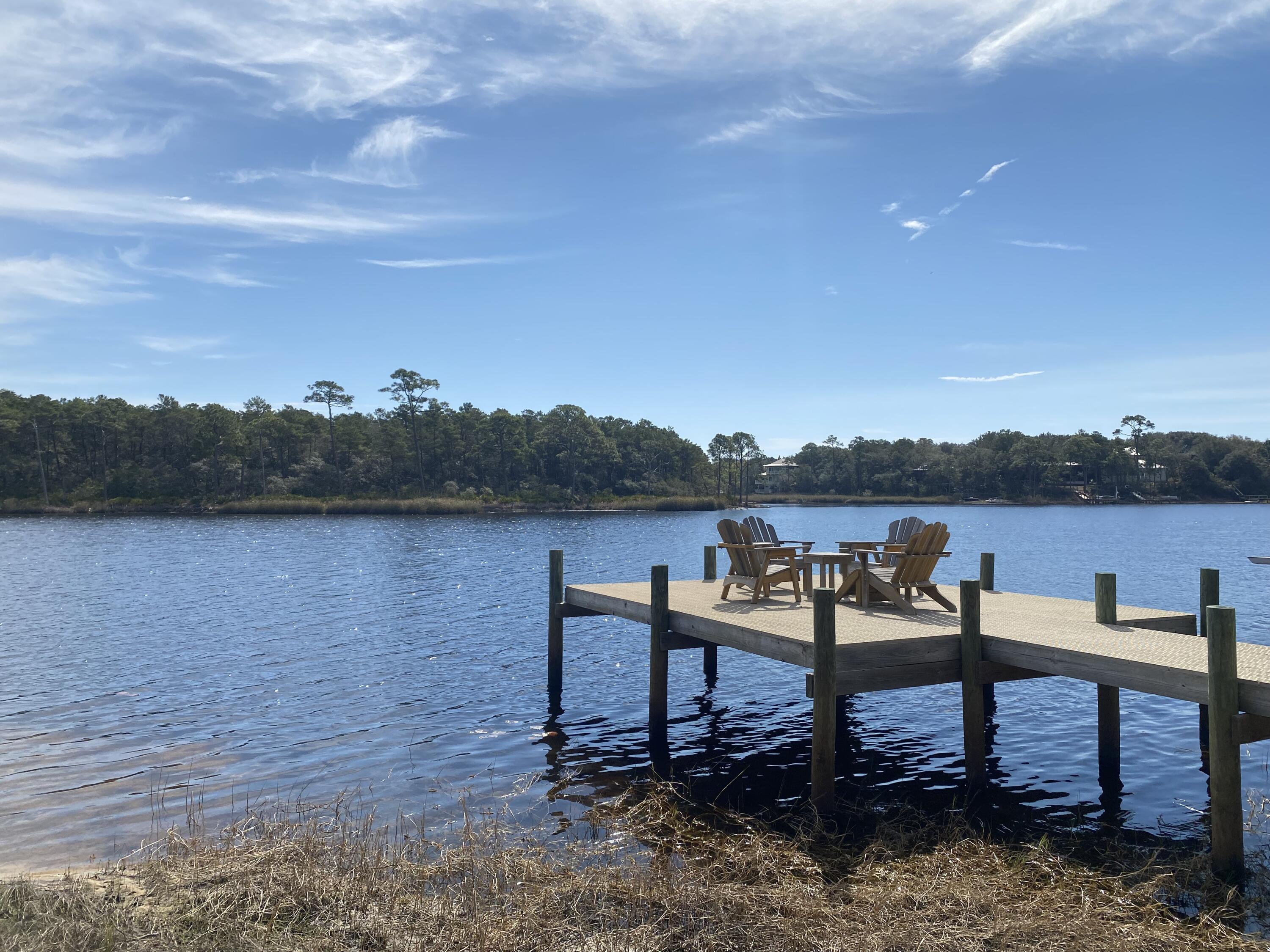 Located on one of 30A's unique and treasured Coastal Dune Lakes, this beautiful home site resides on 67 feet of waterfront on Camp Creek Lake. A private dock is already in place, granting you direct access to the lake and just beyond to the Gulf. You can avoid the crowds and take a stress free boat ride or paddle to your beach chair. Your view across Camp Creek will be beautiful State Land. The Landing at Camp Creek is a quiet, gated community established in 2001 with only 16 home sites. Canopied by mature oaks and pines, this low-density neighborhood provides an abundance of peaceful surroundings and unspoiled nature. The property's is considered Watersound Beach near the HUB, bike to Alys Beach, Seacrest, and Rosemary. You won't find a better spot to build your dream home. *****Buyer is responsible for personally verifying details about this property. Any information contained***