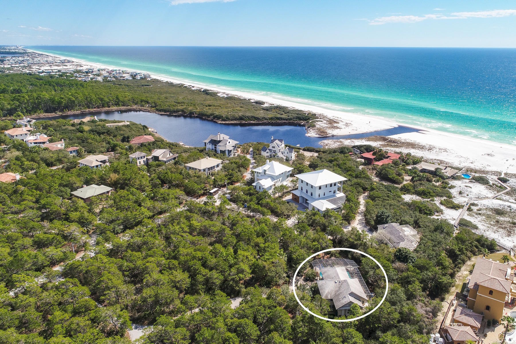 Unparalleled privacy juxtaposed rich naturalistic surroundings characterize this coastal retreat ideally located south of 30A in the exclusive gated enclave of Bannerman Beach. This pristine location offers old Florida character with prominent architectural marvels set aside the coastal backdrop of Little Redfish Lake allowing designated access to one of 30A's most secluded stretch of beach frontage next to Grayton Beach State Park. 40 Whispering Wind Way is set on an impressive estate-sized homesite totaling .63 acres with ample future development opportunity including potential for unobstructed gulf view corridors. The current residence has been well maintained and offers a beautiful courtyard design with a welcoming entryway perfectly framed by seasonal flora including hydrangeas & confederate jasmine. This home is comprised of 4,800 square feet with an outstanding layout catered to entertaining. Notable features include a substantial screened pool area with surrounding oversized pool deck, spacious two car garage as well as additional storage space. The main house offers an abundance of living space with multiple first level bedroom suites as well as a large living room and enclosed patio. The inverted floor plan offers primary living on the second story including a large living room with vaulted ceilings as well as ample windows allowing an abundance of natural light. The chef's kitchen is located right off the main living area and offers excellent cabinet storage, stainless appliances as well as granite counter tops all of which is open to the dining room as well as direct access to the wrap around porch that flows down to the pool area. The master suite is a true retreat allowing it's own private living area as well as a spa-like master bath which features soaring vaulted ceilings, sky light with natural lighting, centered soaking tub, dual vanities as well as a large walk-in closet with ample storage space. Other notable features include an attached private guest suite, accessible through the front courtyard complete with one bedroom and a living room as well as a fully functional kitchen. There are also additional onsite structures including detached storage as well as an elevated sun deck tucked on the western elevation. This premier location in Bannerman allows for quick access to the new beach walkover that is almost completed which is due south of 40 Whispering Wind Way. Bannerman Beach is centrally located on the west end of 30A with close proximity to Watercolor & Seaside as well as all of the world class shopping, dining and entertainment that South Walton has to offer.