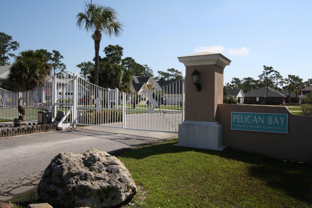 Located in the gated, bay front subdivision of Pelican Bay you will enjoy living in this exceptionally located community. Pelican Bay amenities include tennis court and bay front dock with park. You can pull your boat up to the community dock allowing easy loading for your family and friends or climb down the ladder for and play in the bay. LOW HOA's. Near shopping, restaurants and entertainment of Grand Boulevard, close to hospital and just minutes to the beach this lot is one not to pass up. Are you ready to build your dream home?